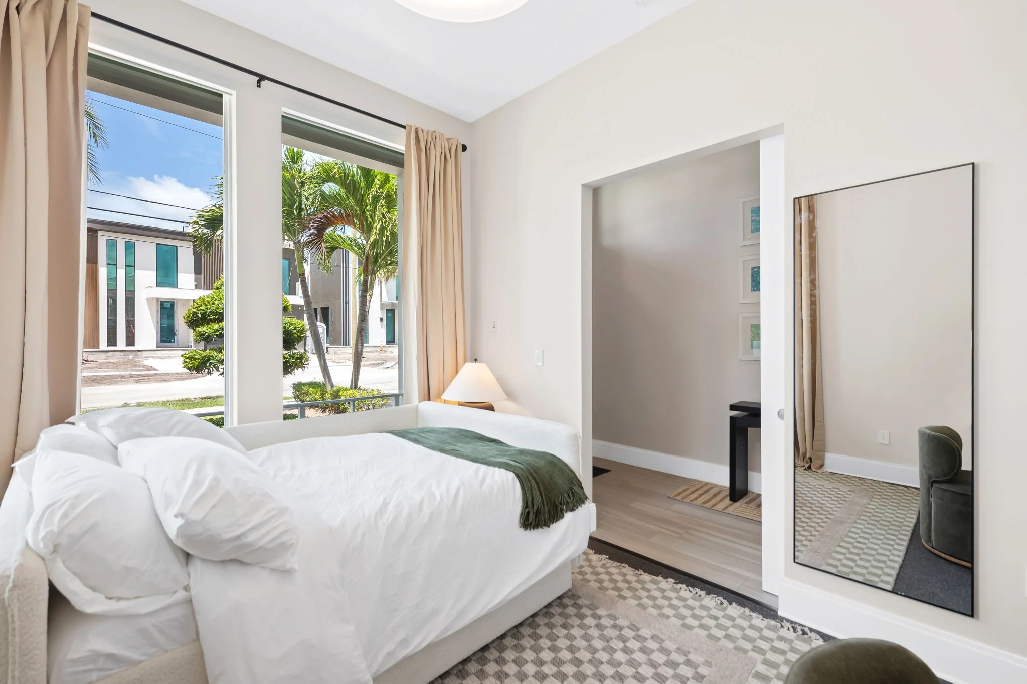 Guest bedroom with palm tree and city views — Sun Haven Collection luxury vacation rental, Fort Lauderdale.