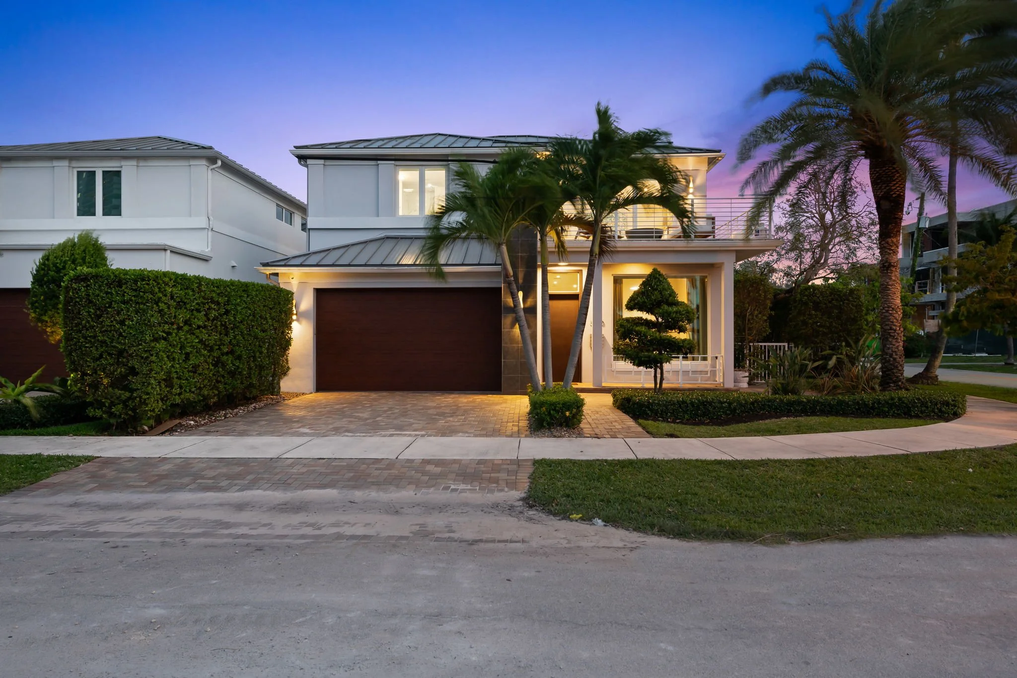 Private balcony at golden hour with pink-purple sky — luxury vacation home, Sun Haven Collection.