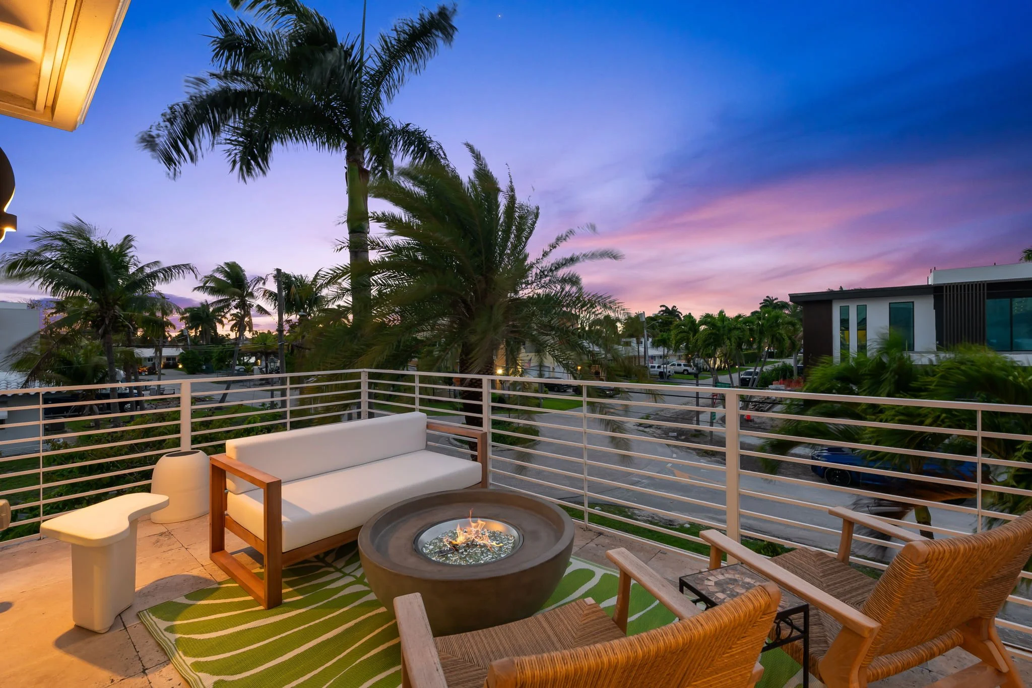 Sunset balcony with fire pit and city skyline views — Sun Haven Collection luxury vacation rental.