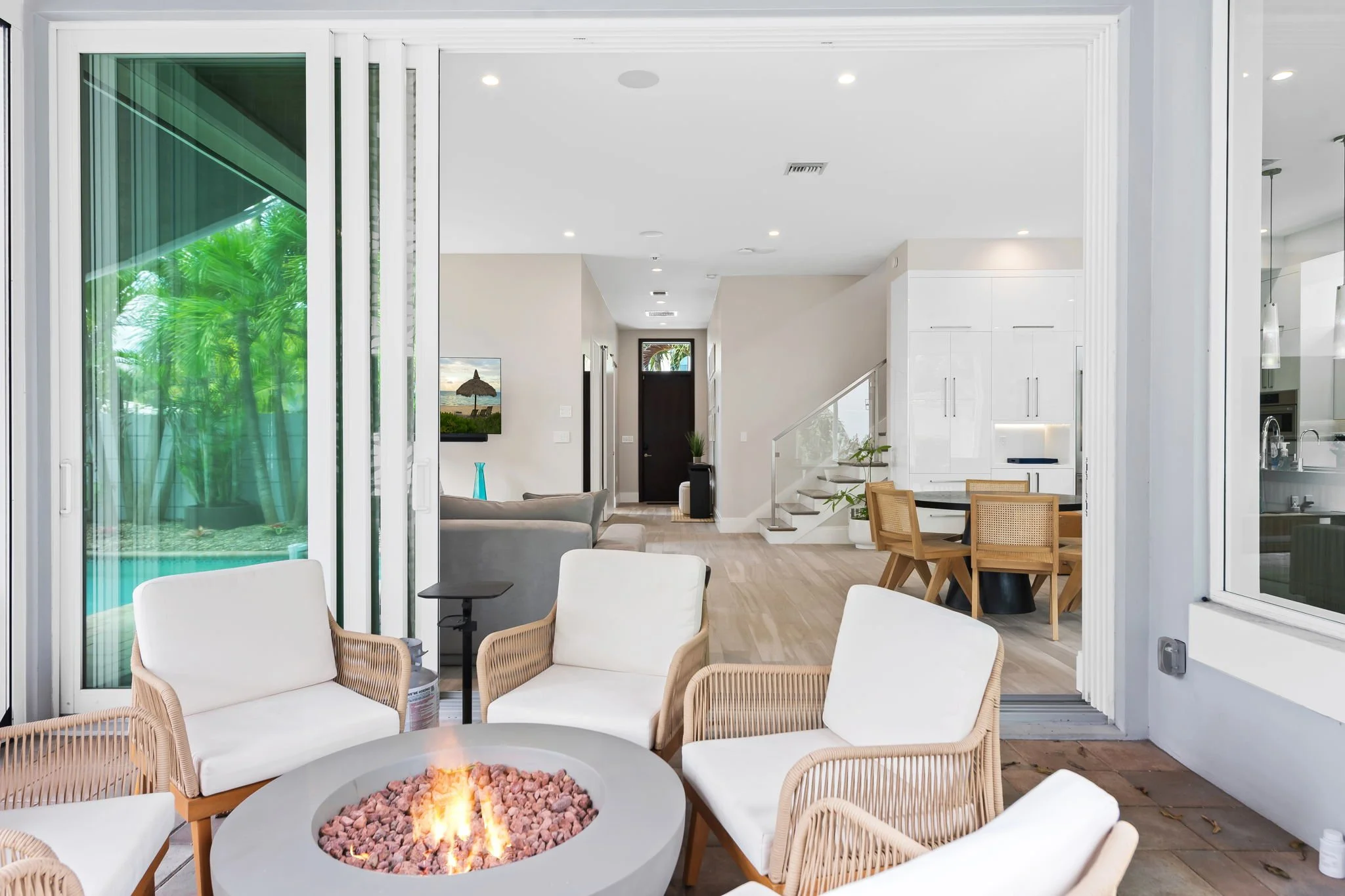 Open-plan living space viewed through glass doors — Sun Haven Collection design-forward vacation rental.