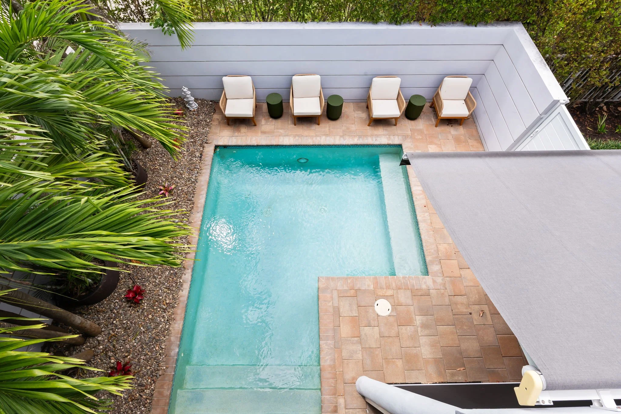 Poolside dining patio with seating for six — Sun Haven Collection luxury vacation rental amenity.