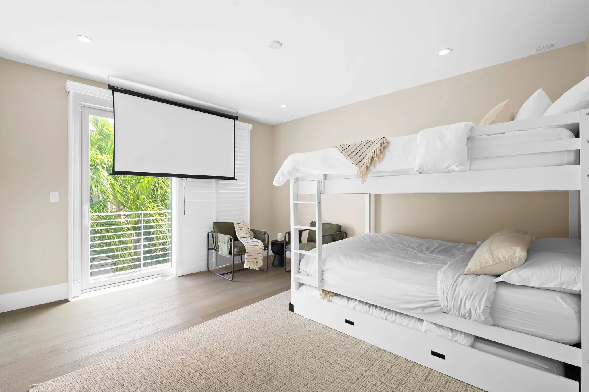 Double bunk room with projector screen — Sun Haven Collection family-friendly luxury vacation rental.