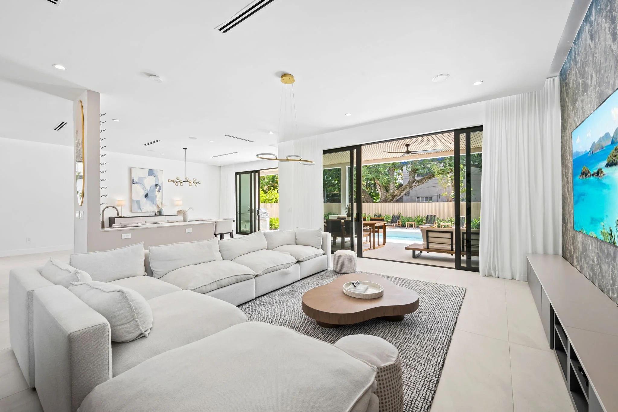 Spacious living room with indoor-outdoor flow and patio views — Sun Haven Collection luxury vacation rental.