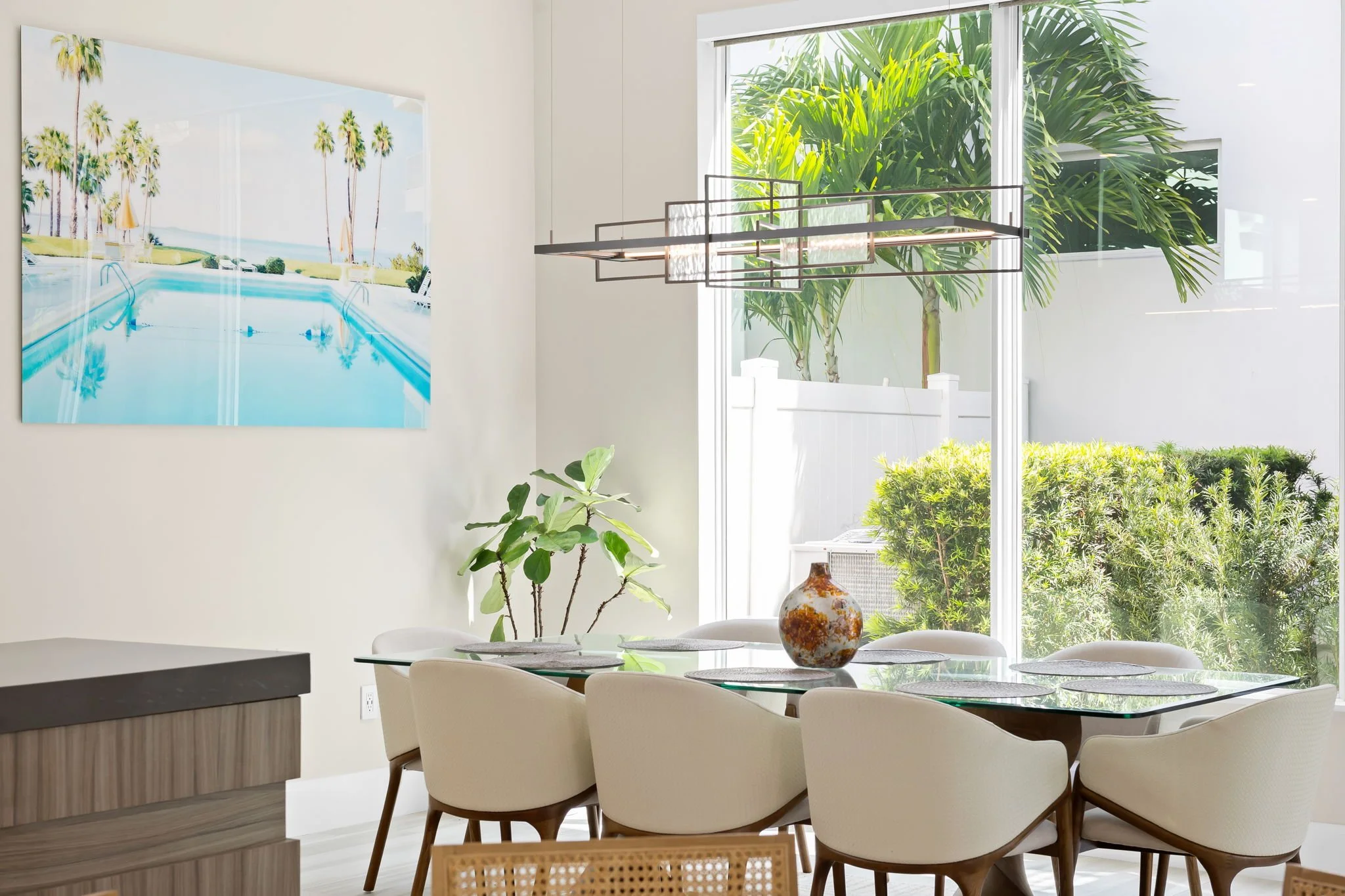 Modern dining room with abstract art and garden views — luxury vacation home, Sun Haven Collection.