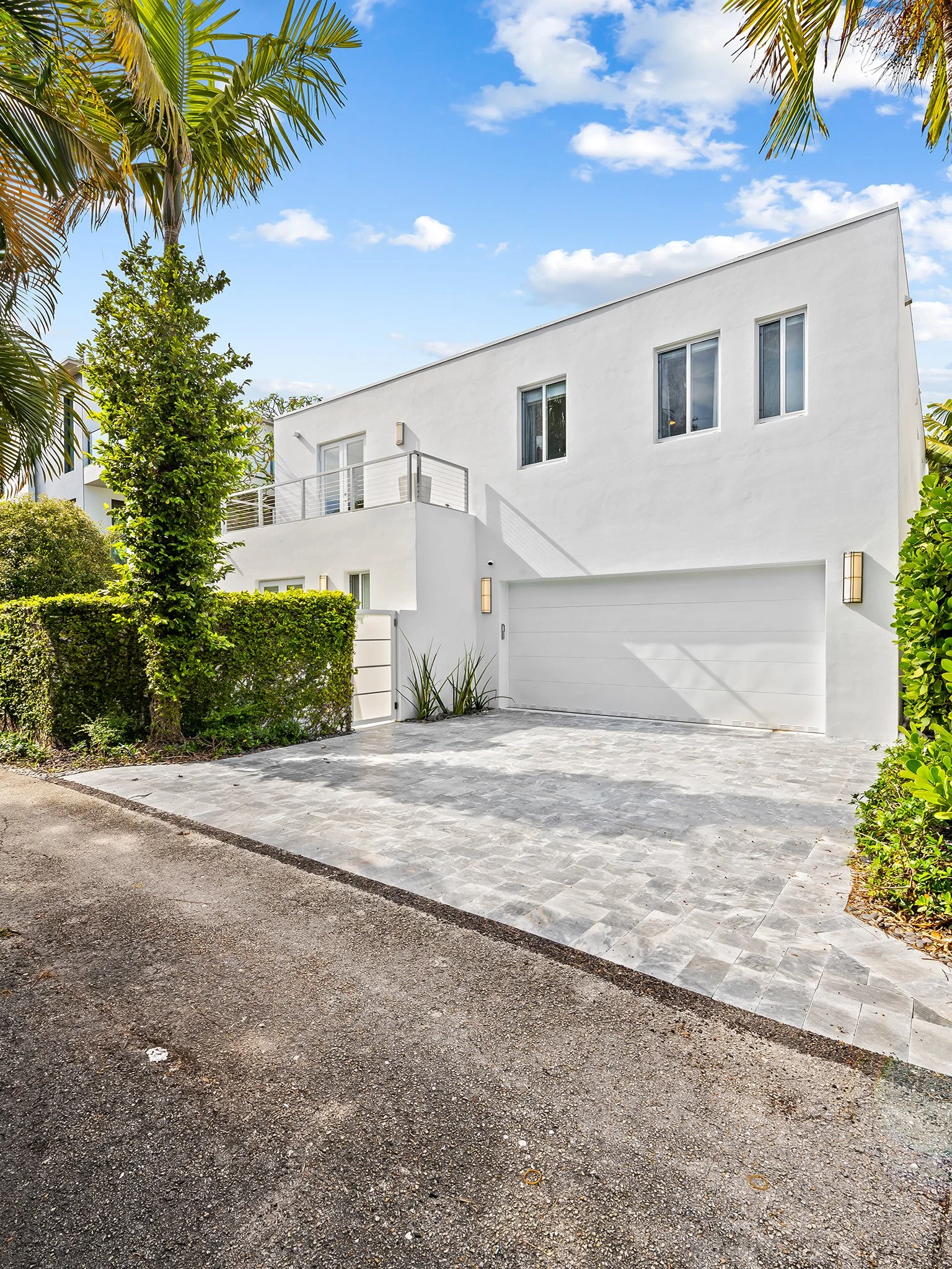 Modern flat-roof vacation home with balcony and tropical setting — luxury rental, Sun Haven Collection.