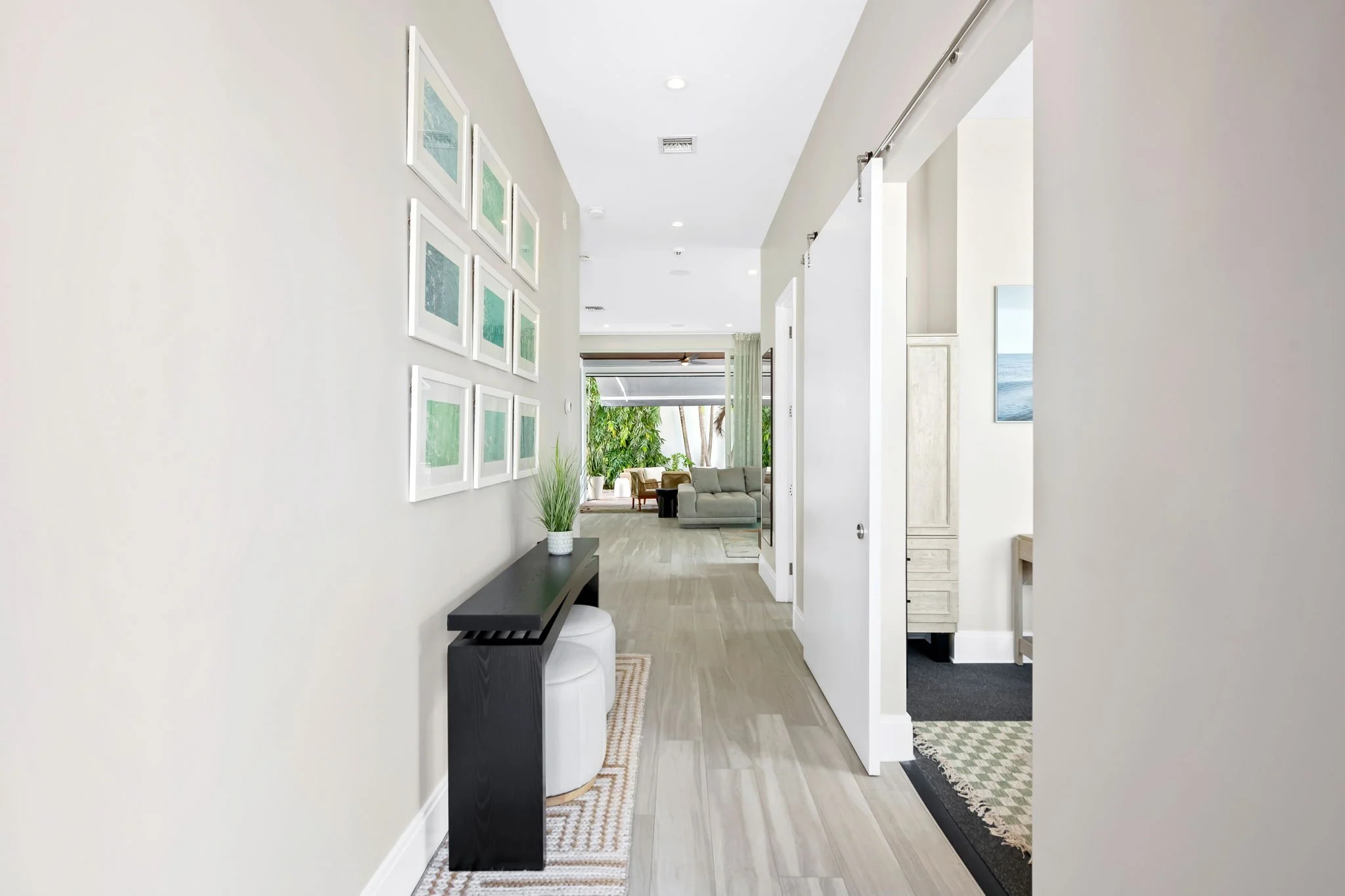 Open hallway leading to living room with garden views — luxury vacation rental, Sun Haven Collection.