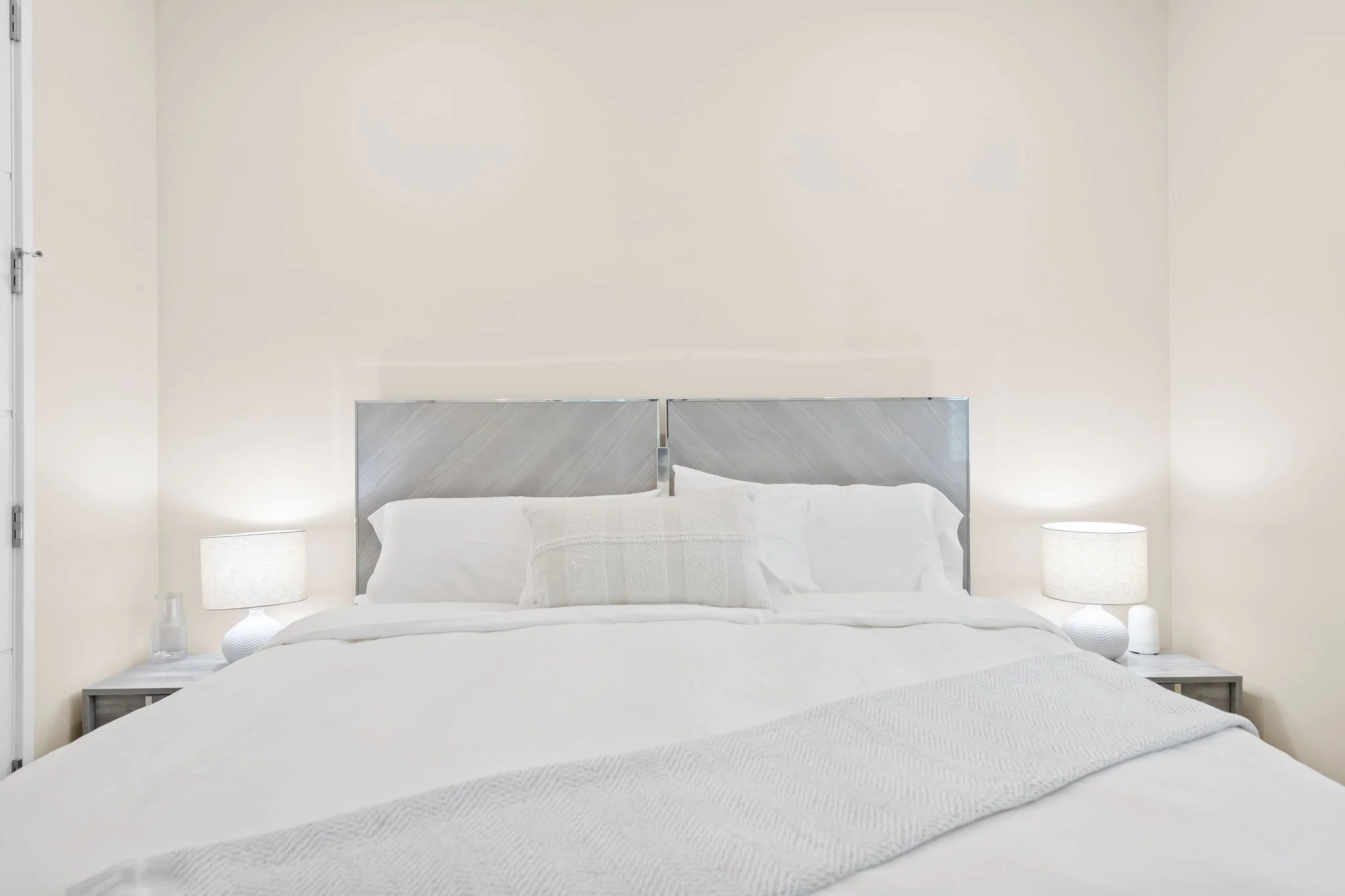 Bright bedroom with smart TV and full-length mirror — Sun Haven Collection luxury vacation rental.