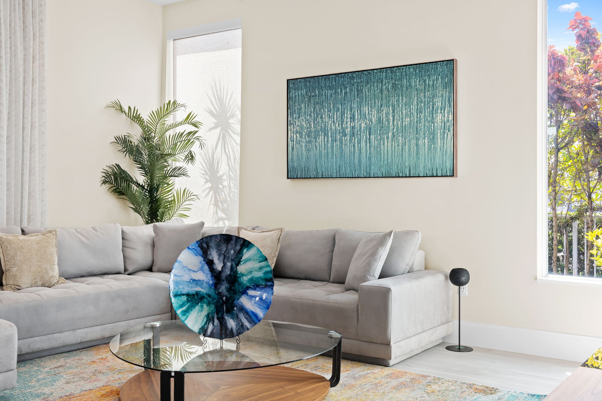 Bright living room with abstract art and natural light — luxury vacation home, Sun Haven Collection.