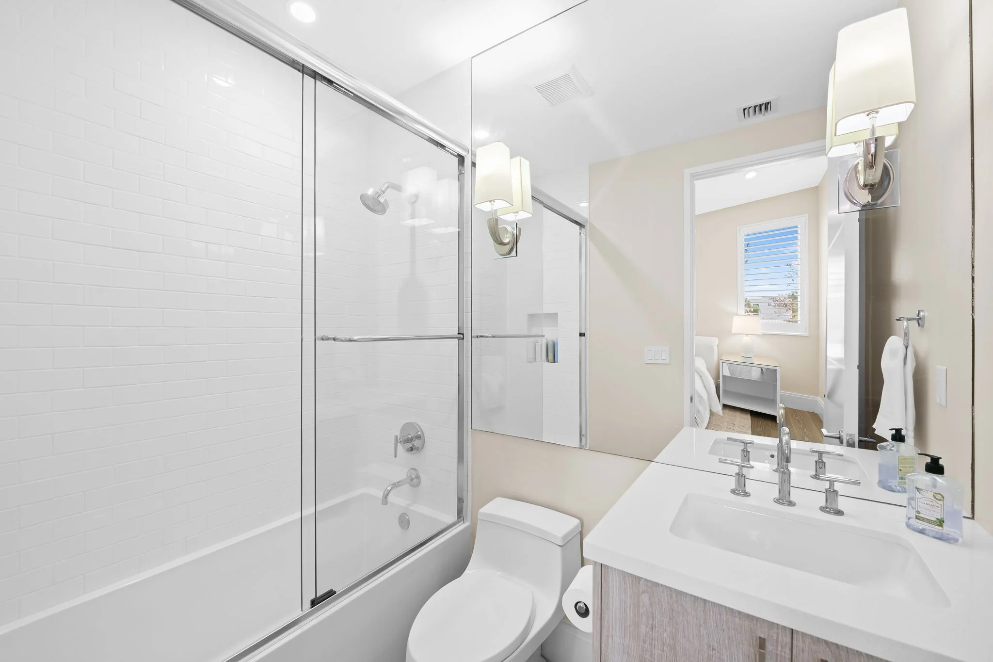 Spa-style bathroom with soaking tub and glass shower — luxury vacation home, Sun Haven Collection.