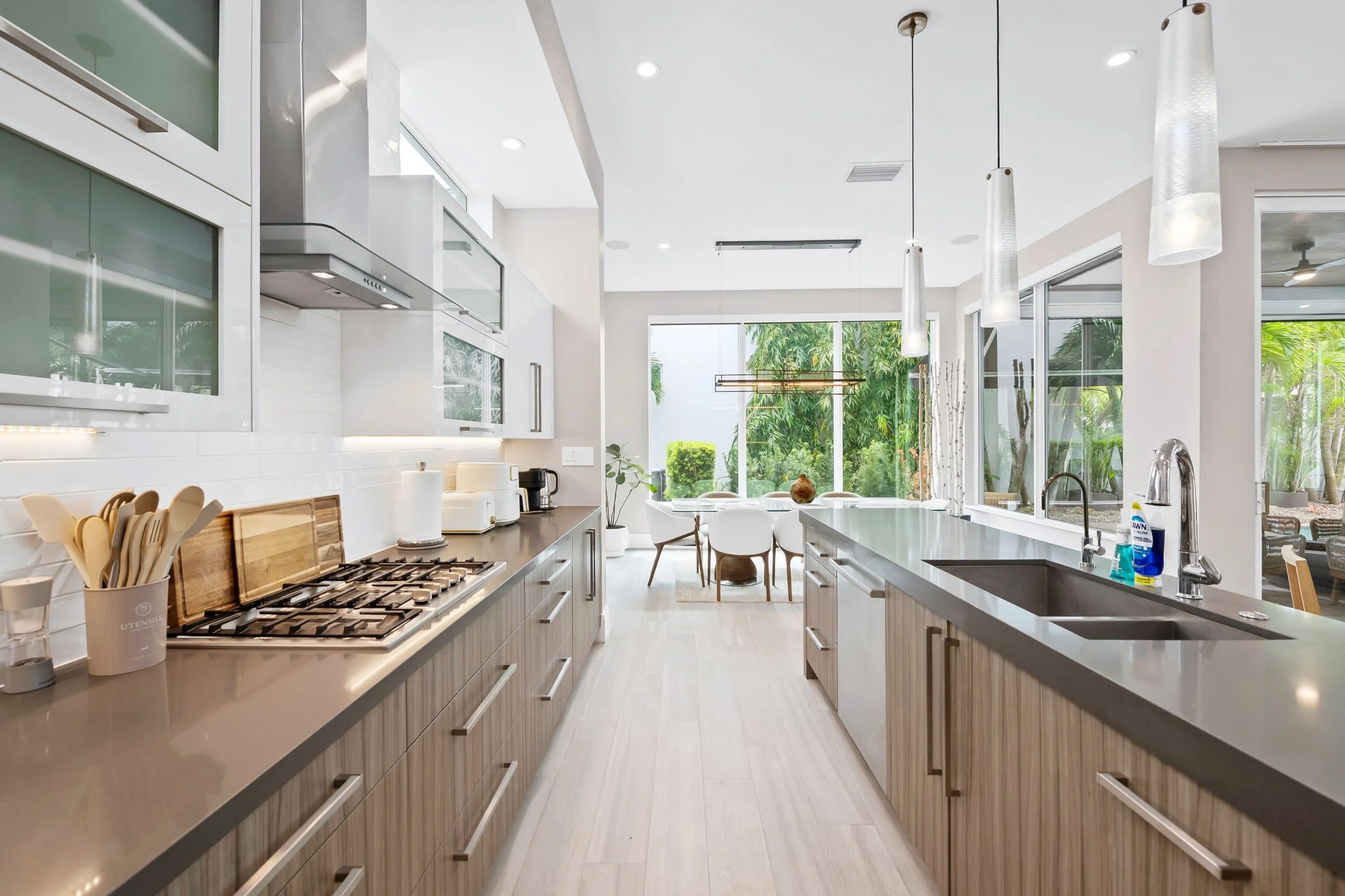 Chef's kitchen with subway tile backsplash and garden views — luxury vacation home, Sun Haven Collection.