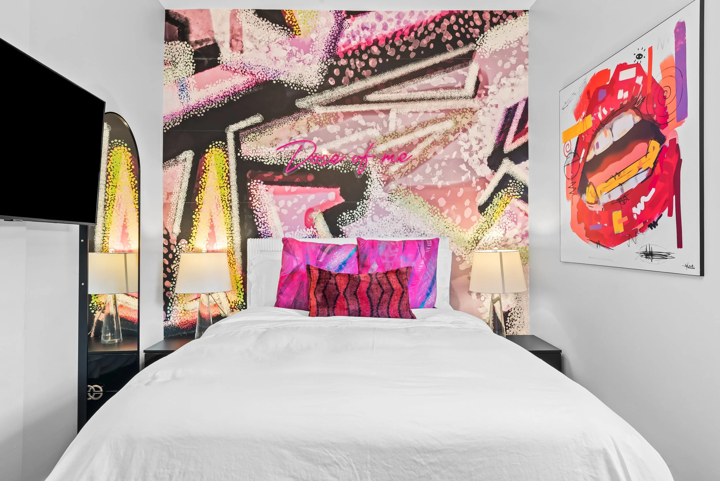Psychedelic-art bedroom with statement mural and designer bedding — luxury vacation home by Sun Haven Collection.