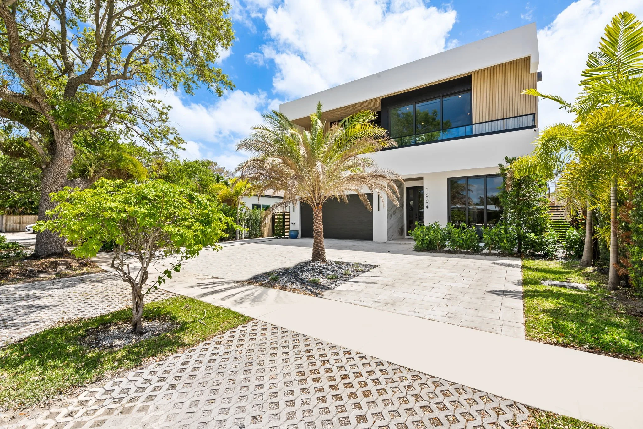 Contemporary vacation home surrounded by lush tropical gardens — luxury rental by Sun Haven Collection.