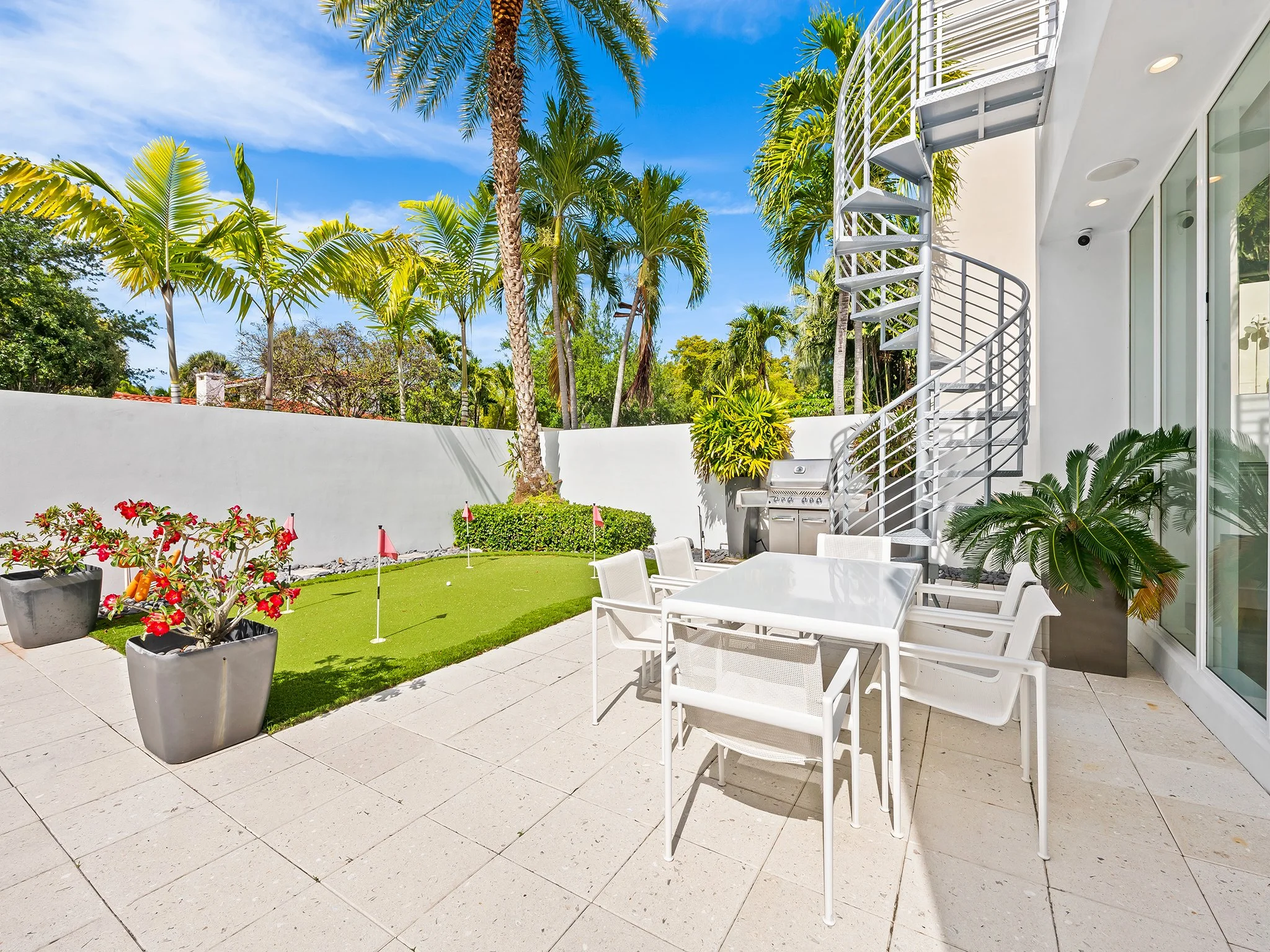 Private patio with putting green and BBQ area — luxury vacation rental by Sun Haven Collection.