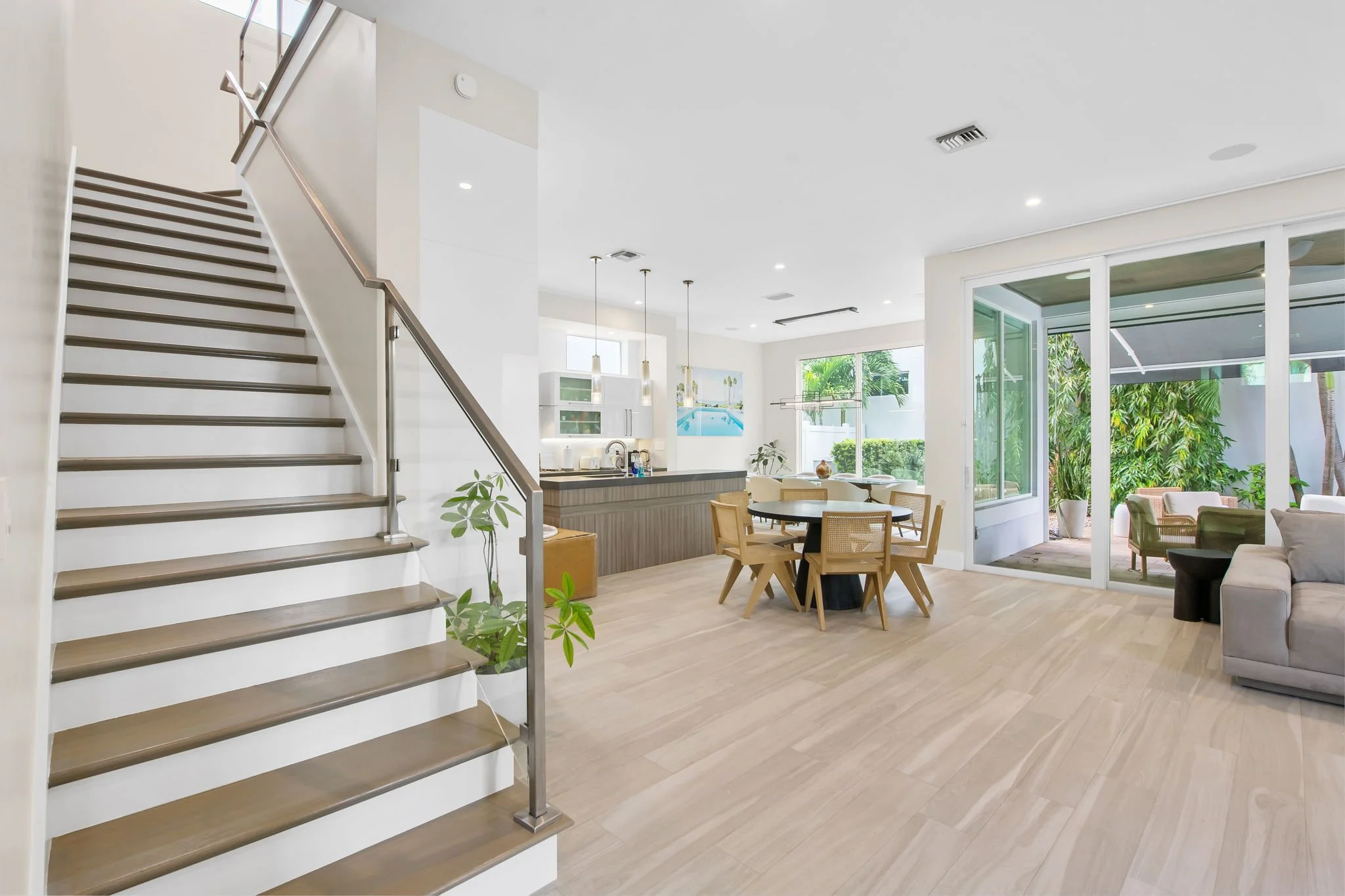 Bright open-plan living space with patio views — Sun Haven Collection luxury vacation rental.