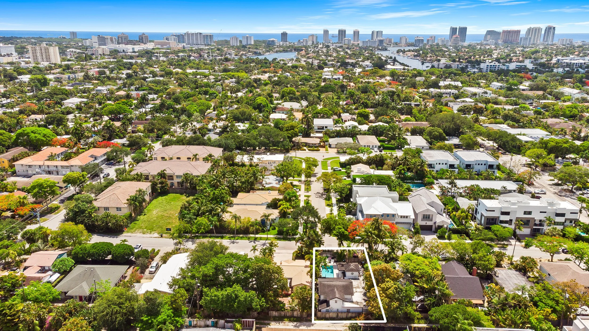 Aerial view of coastal neighborhood near ocean — Sun Haven Collection luxury vacation rental location.