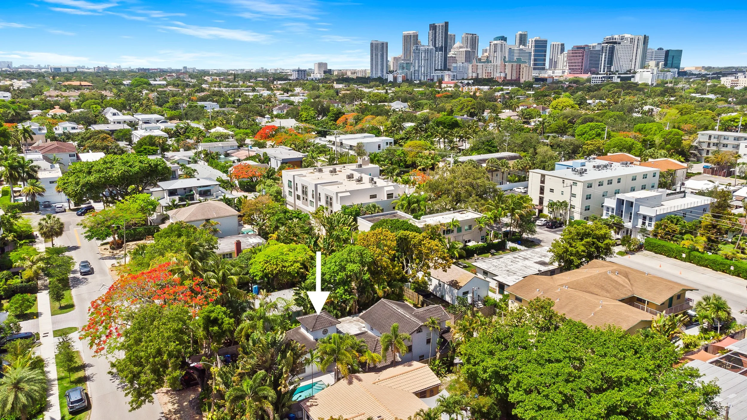 Aerial neighborhood view with city skyline — Sun Haven Collection luxury vacation rental location.