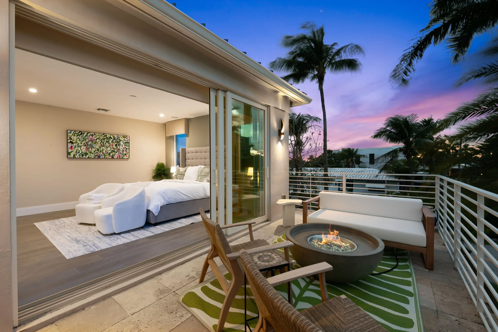 Rooftop fire pit with palm trees at sunset — luxury vacation rental by Sun Haven Collection.