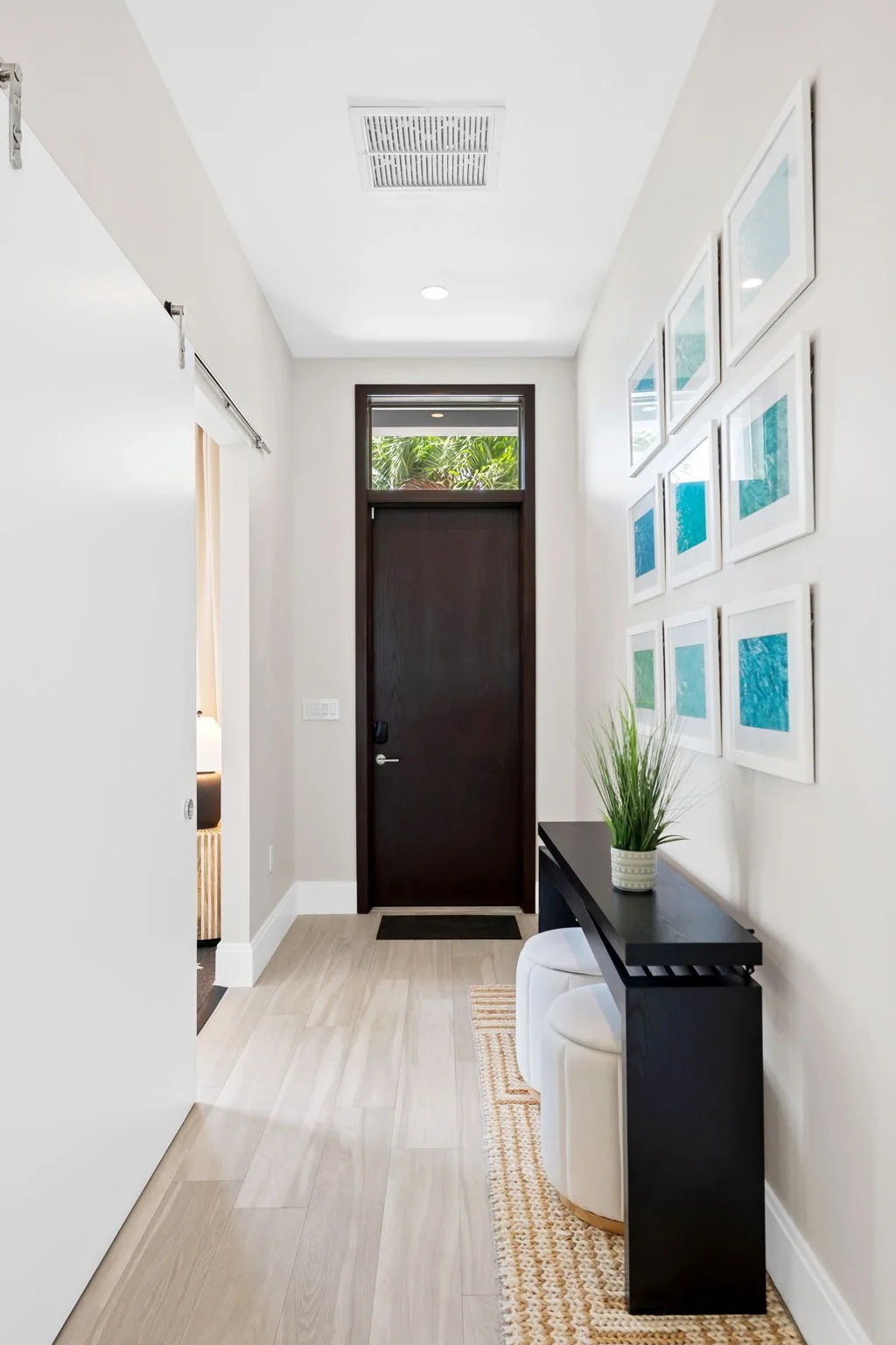 Welcoming entryway with curated art and designer touches — Sun Haven Collection luxury vacation home.