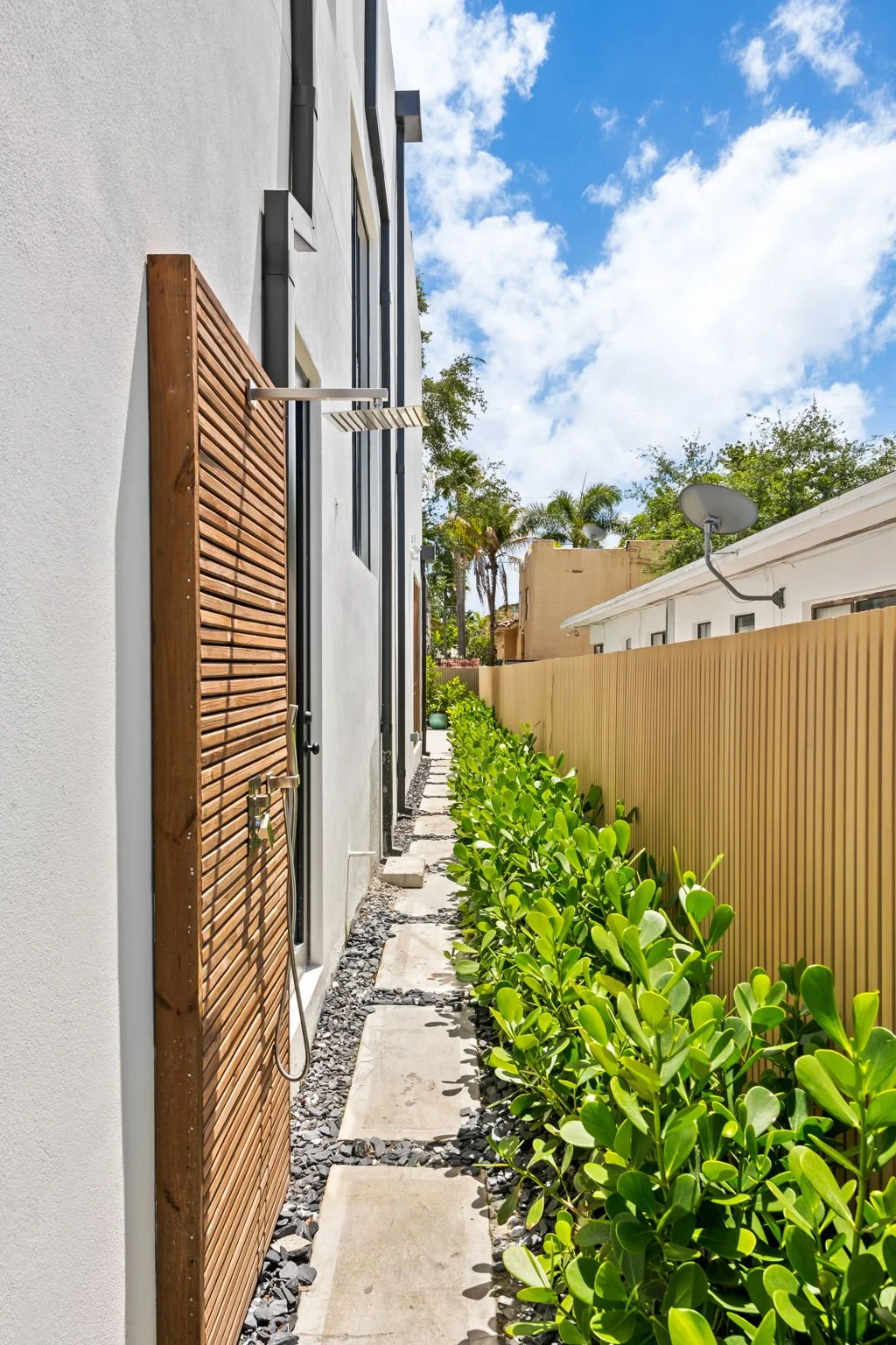 Landscaped side yard of modern luxury vacation rental — Sun Haven Collection.