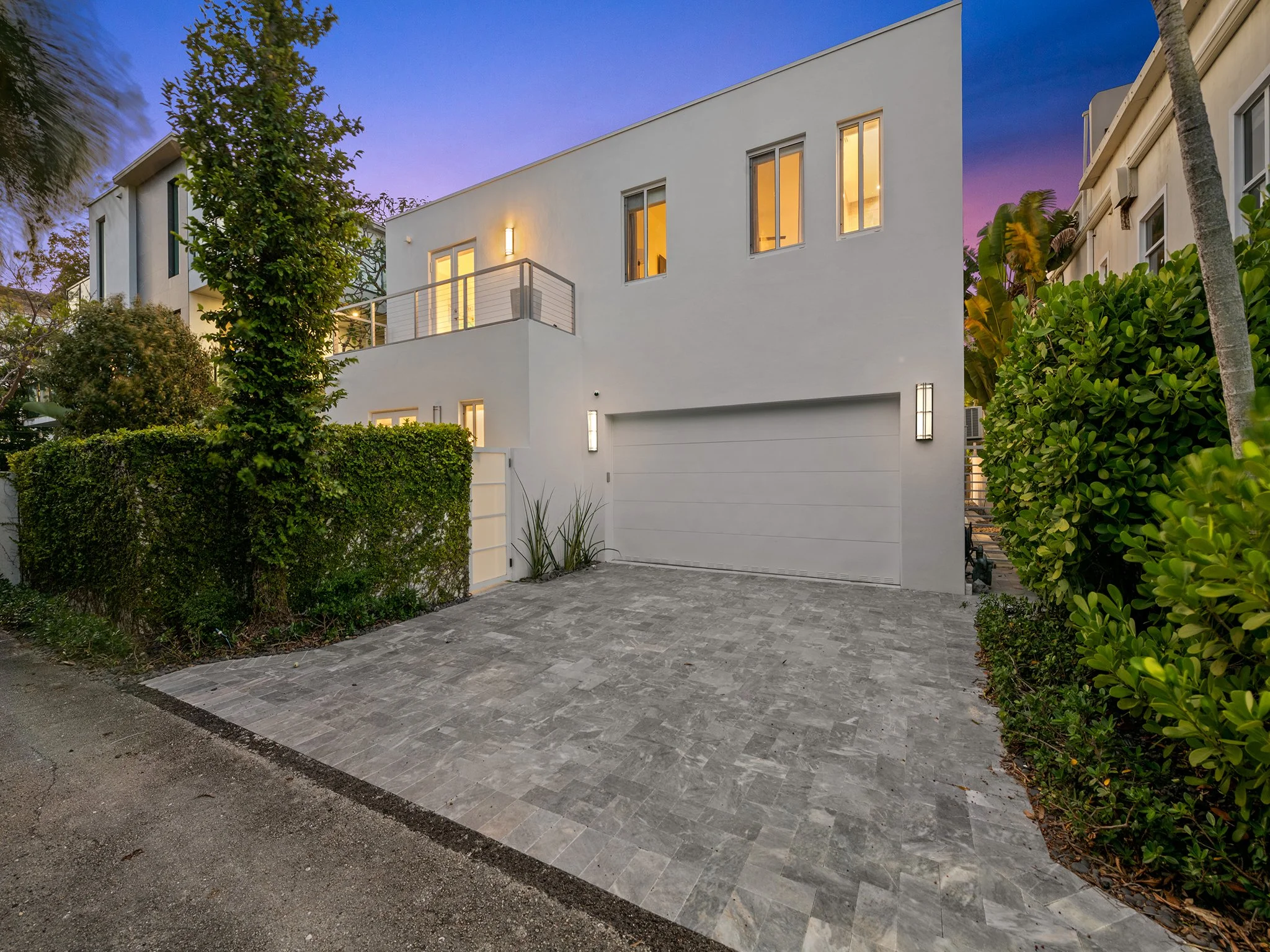 Design-forward vacation rental illuminated at dusk — luxury home by Sun Haven Collection.