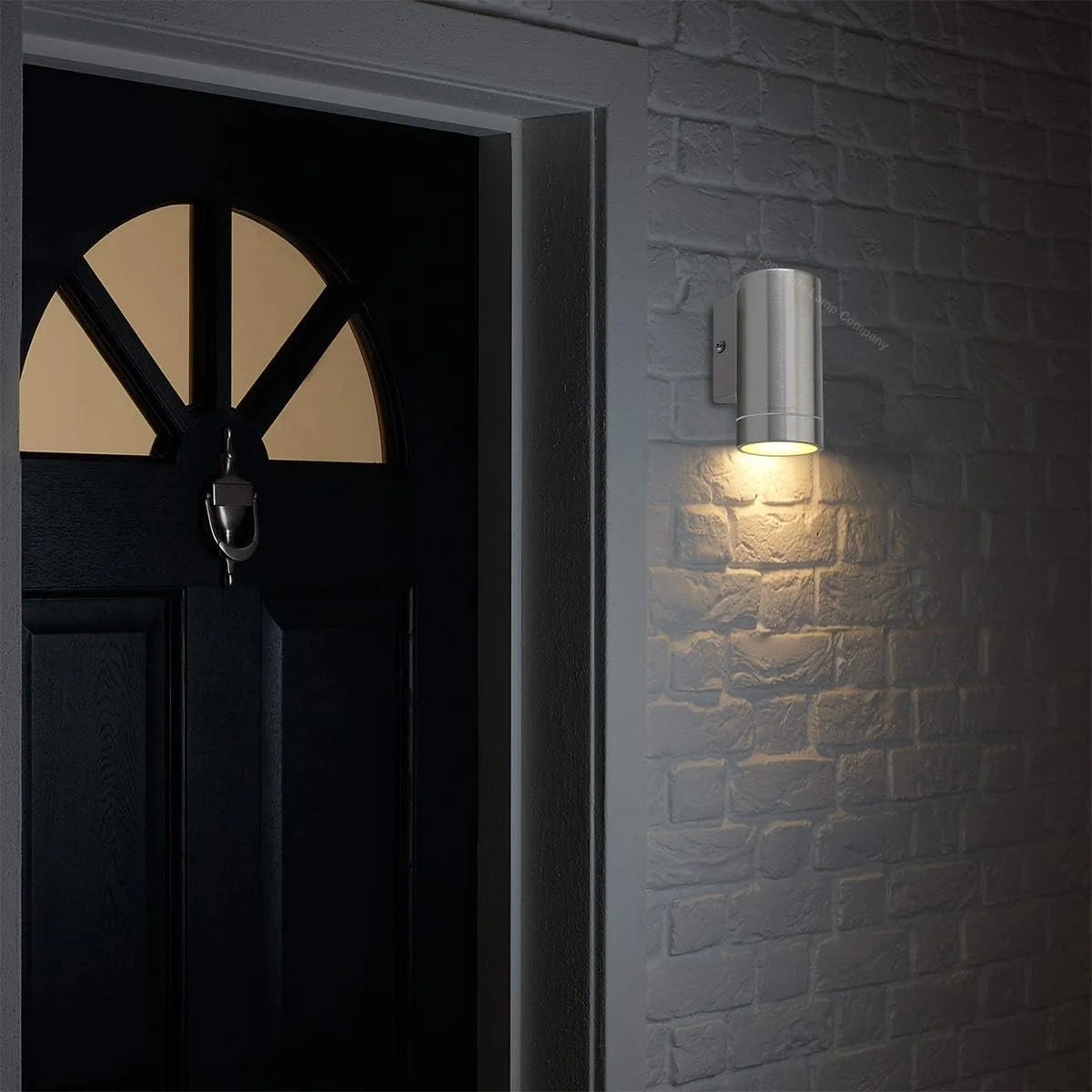 outdoor metal wall light next to door