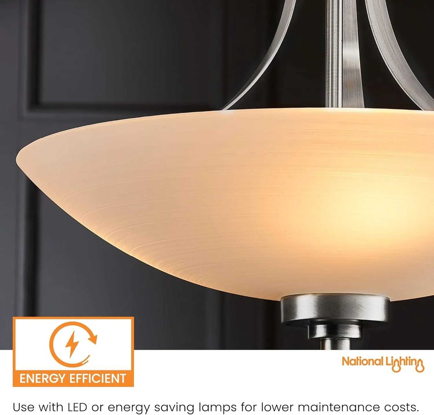 Close-up of a modern ceiling light fixture with a frosted glass shade, illuminated, with dark walls in the background.