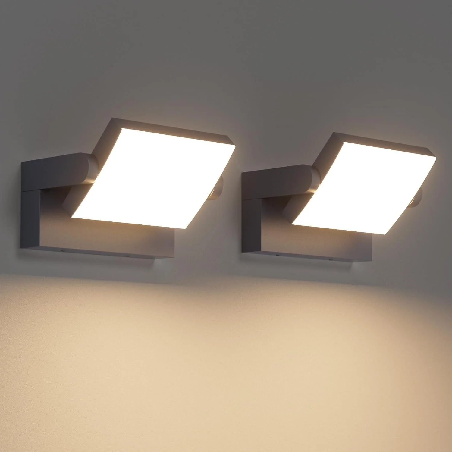 Two wall-mounted modern square LED light fixtures illuminating a wall.