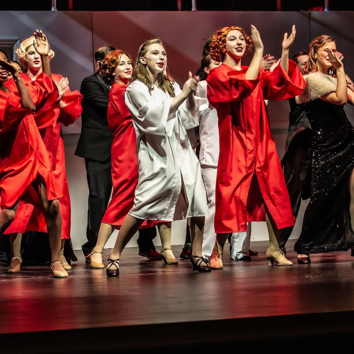 Grace Nelson as Reno Sweeney in Blow Gabriel Blow in Anything Goes broadway musical. A group of women in vintage style dresses and high heels dancing on stage, performing a scene from 'The Sound of Music' as nuns.