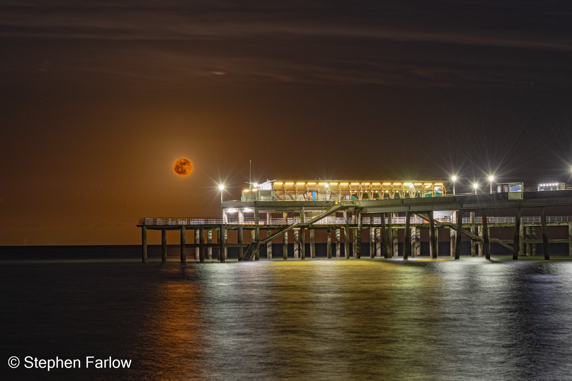 Deal pier with "pink" full moon