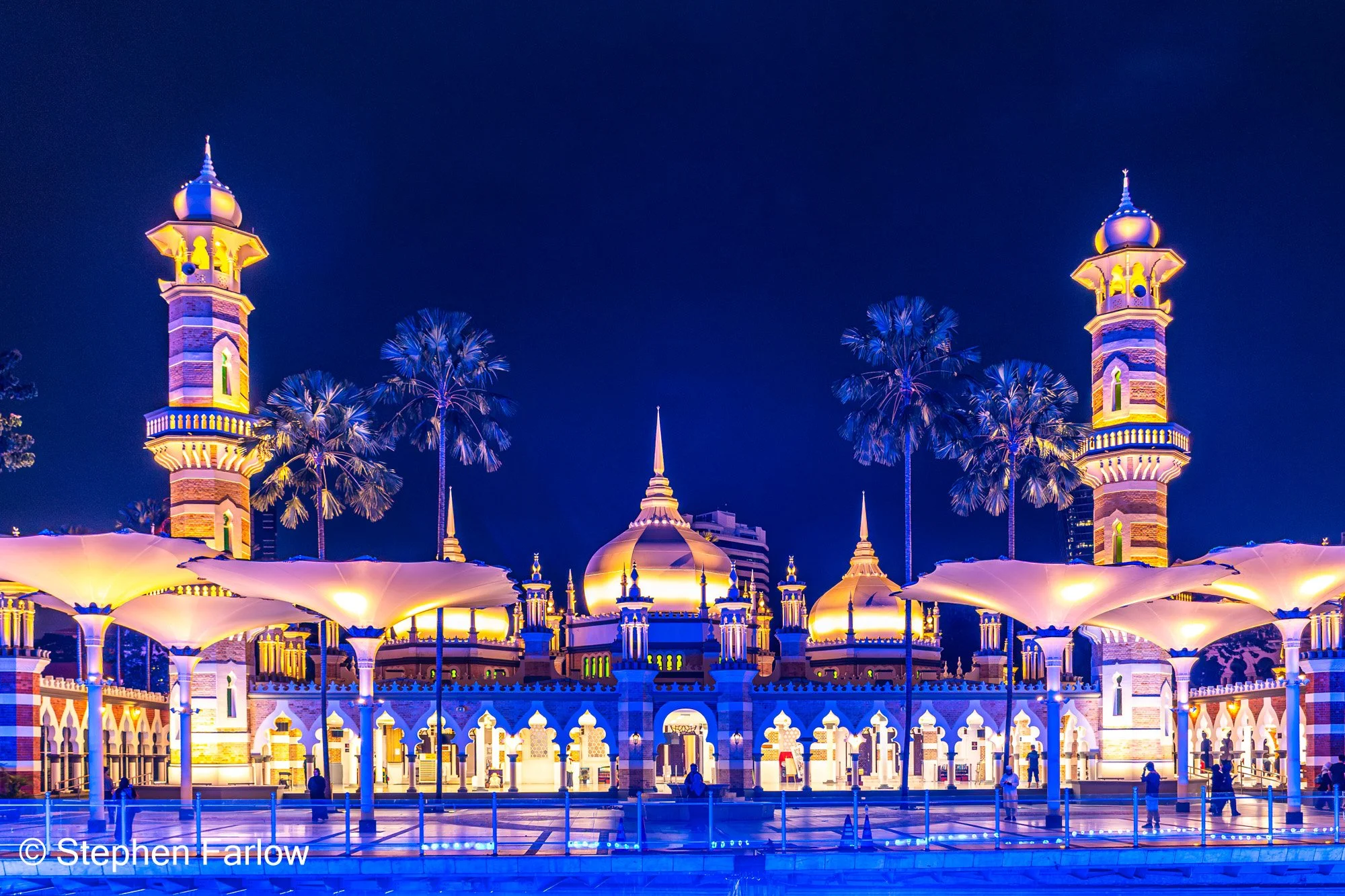 Masjid Jamek with the blue lights of the River of Life