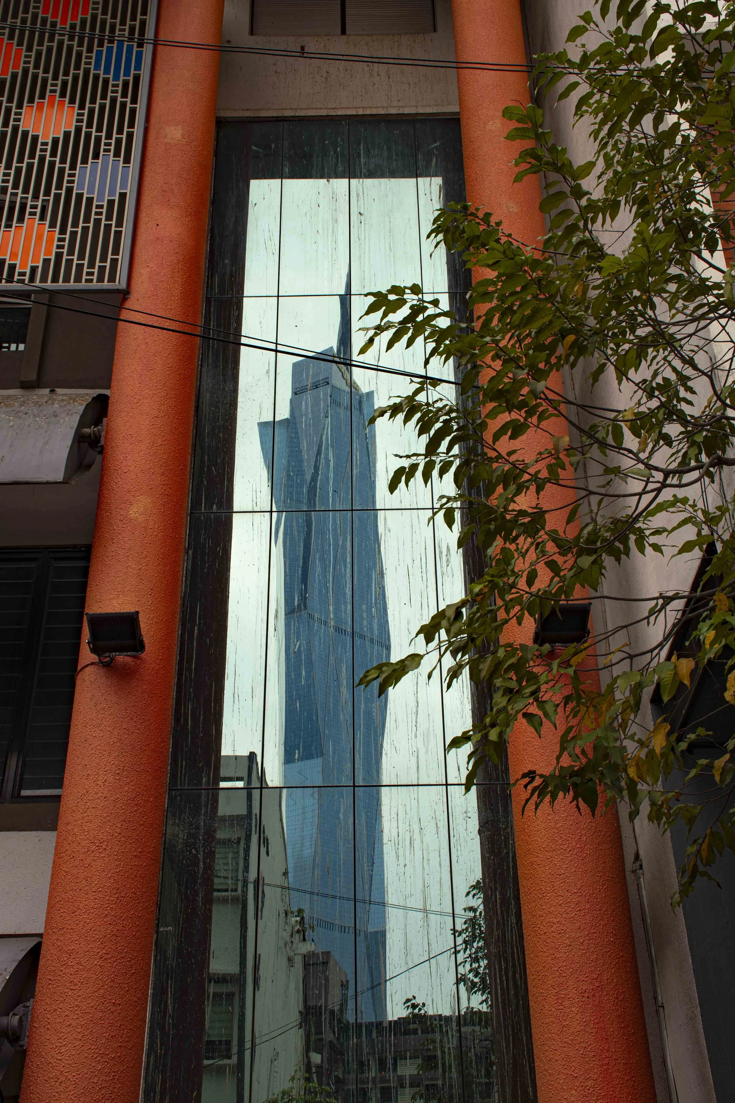 Reflection of Merdeka 118 in a building in Kampung Attap