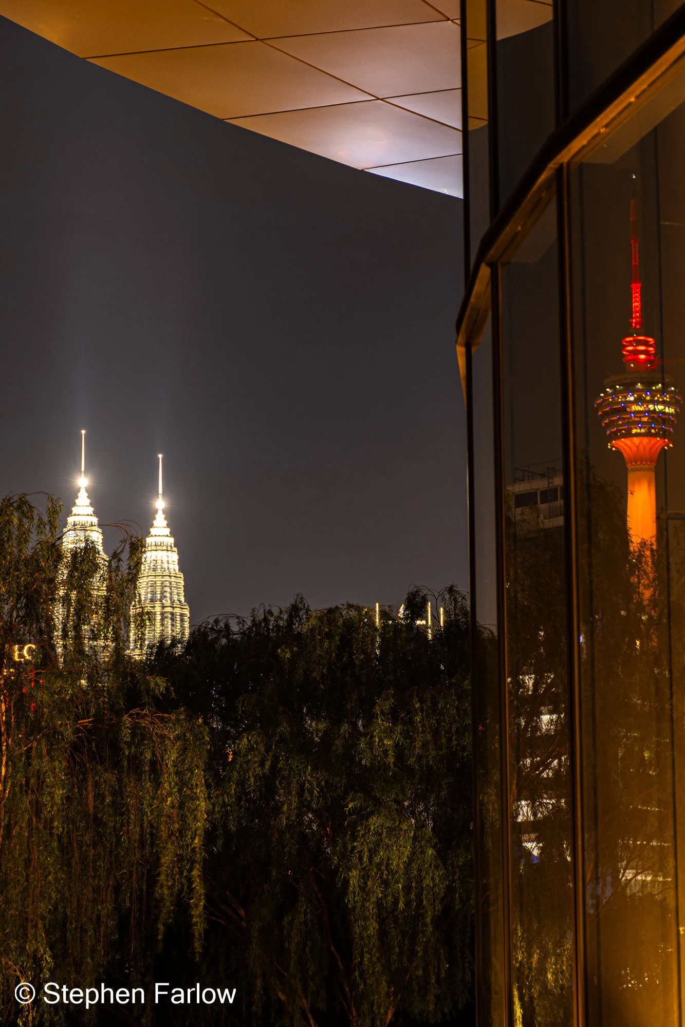 Petronas Twin Towers with KL Tower reflected