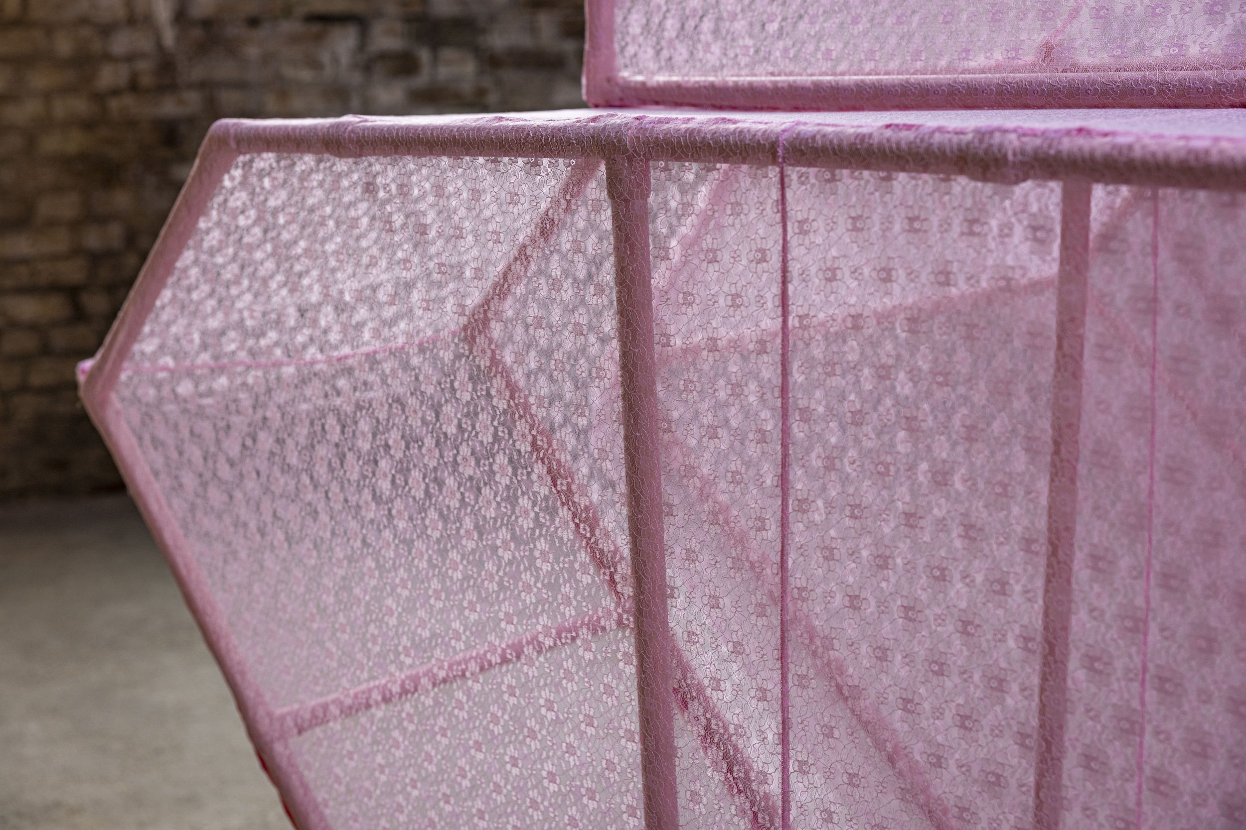 A detail image of Power Play showing a close up of the taught lace fabric stretched over the tank frame.