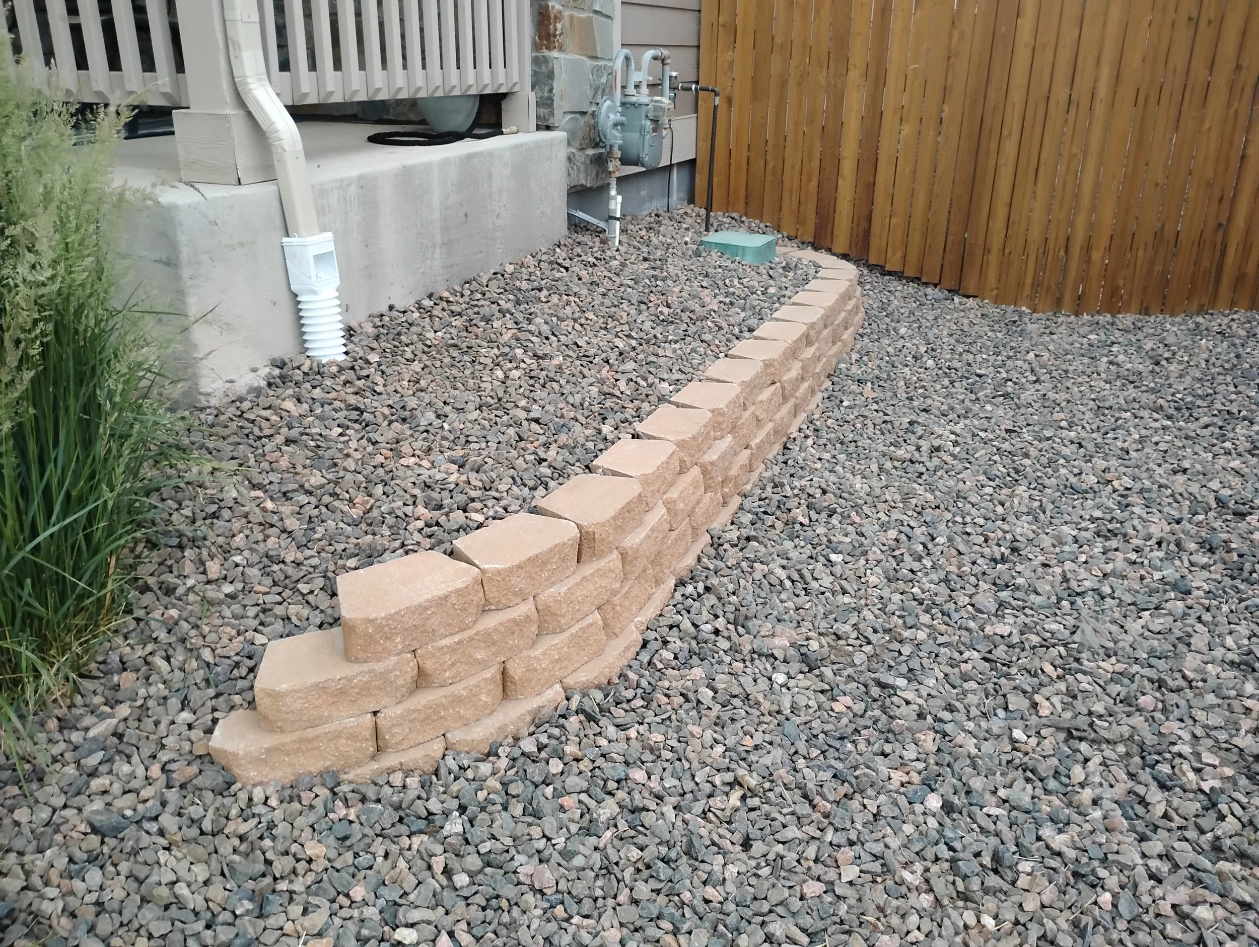 Retaining wall and rock bed to stop erosion of stairs.