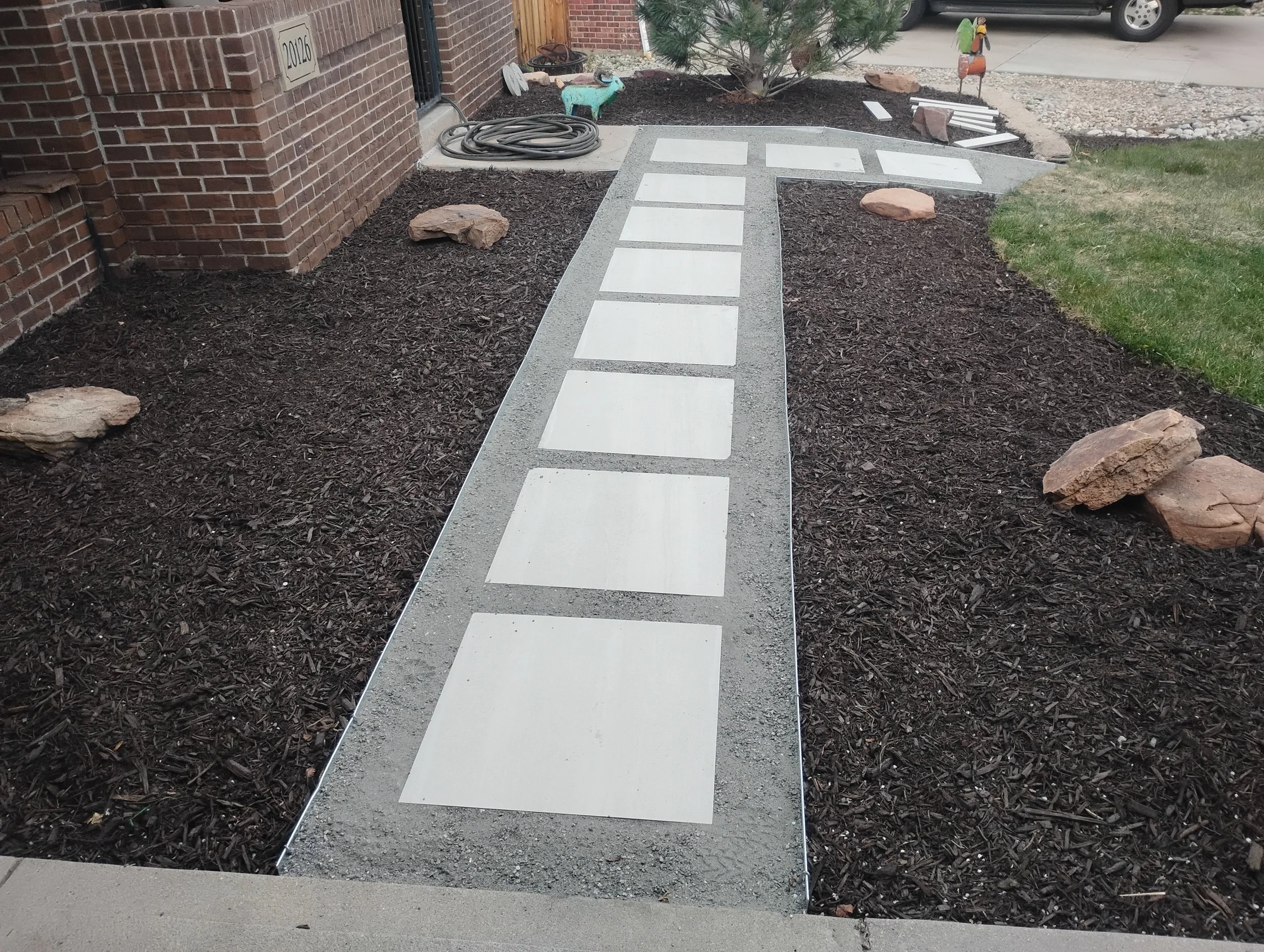 A pathway to a front door made by pavers.