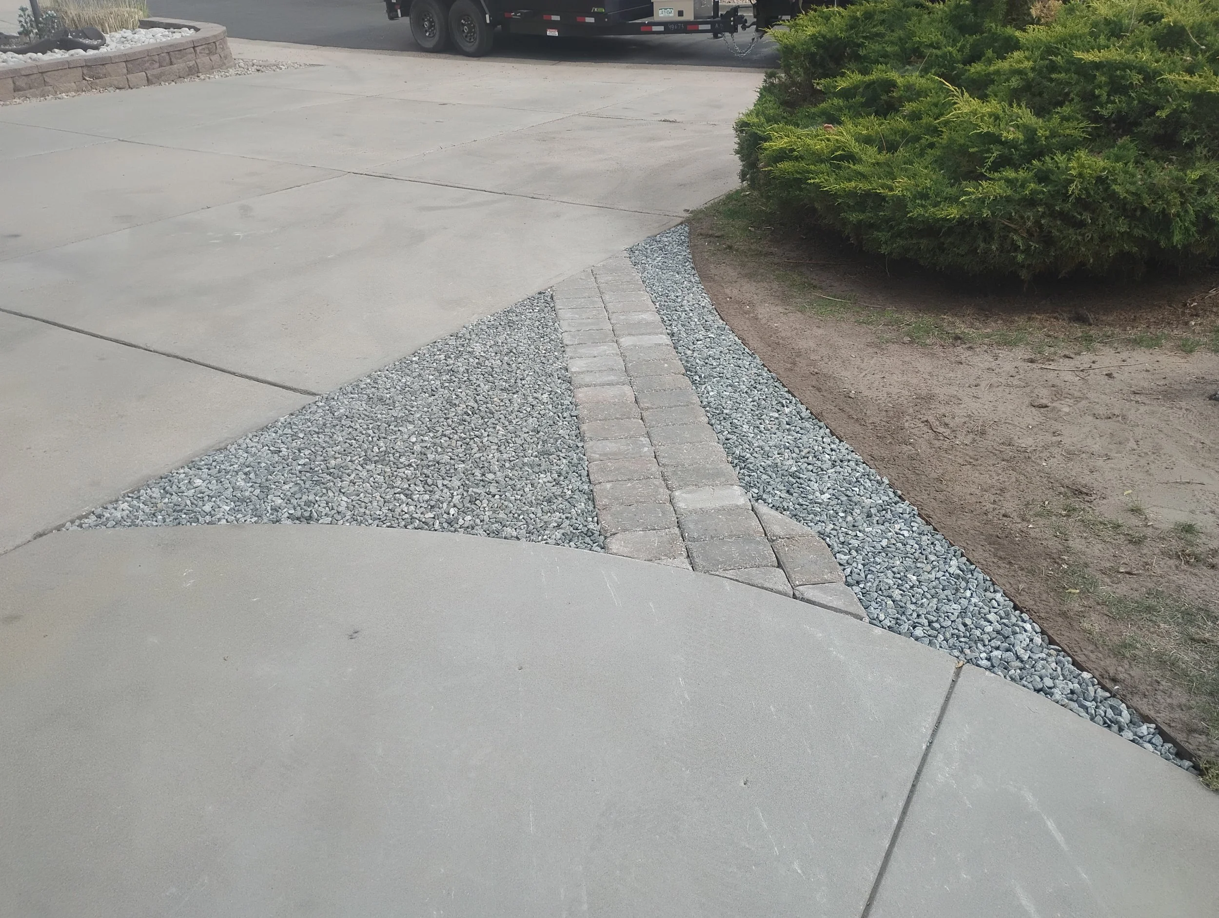 Corner connecting driveway and walk-way, filled in by beautiful stone and brick-work.