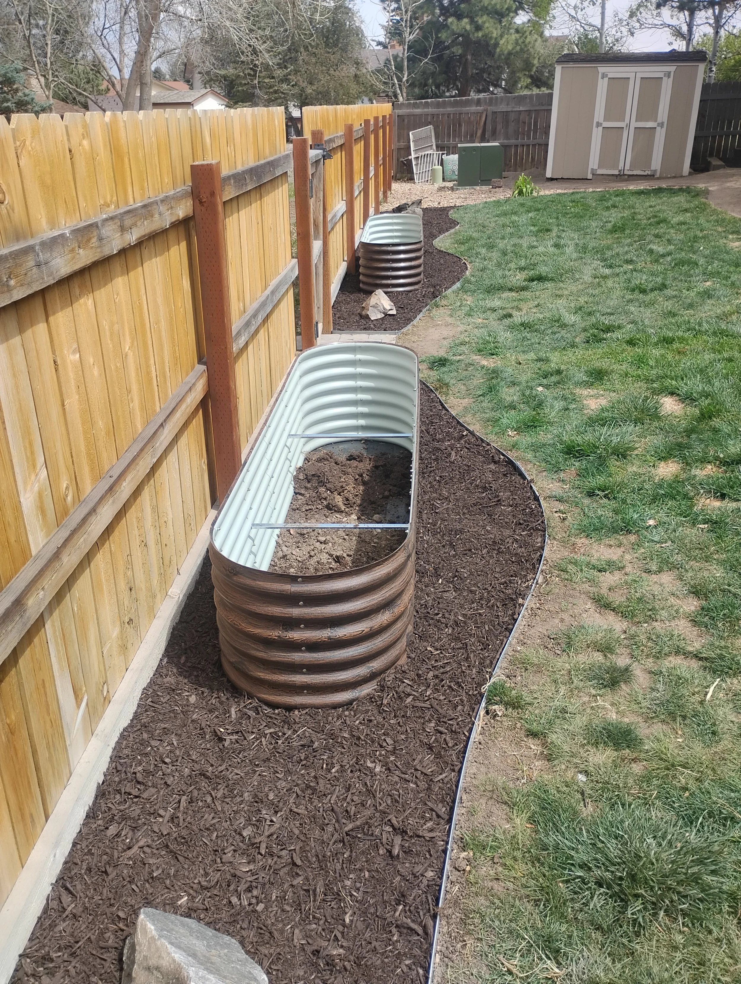 New mulch beds around a backyard.