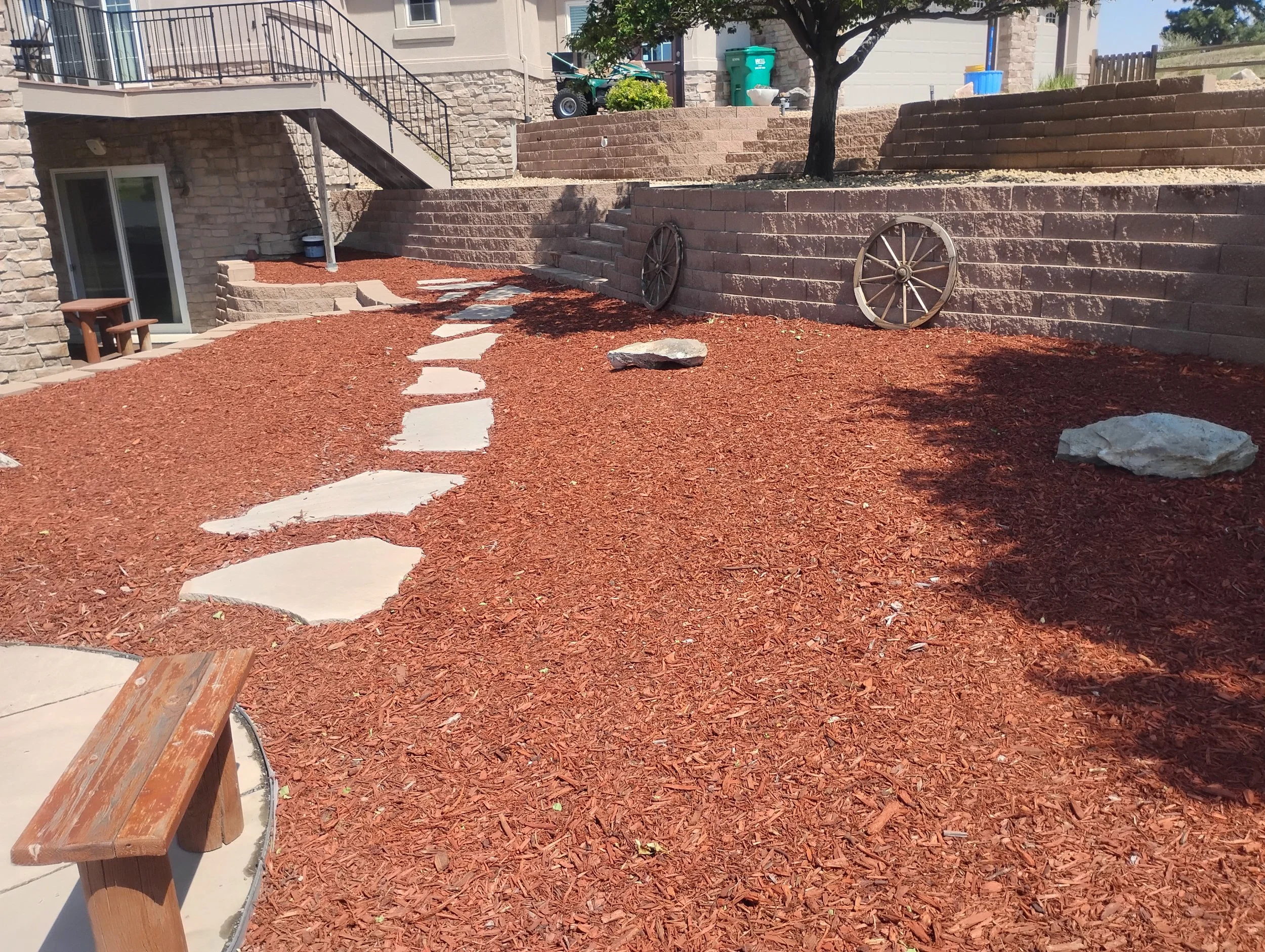 Red mulch bed with a flagstone pathway.