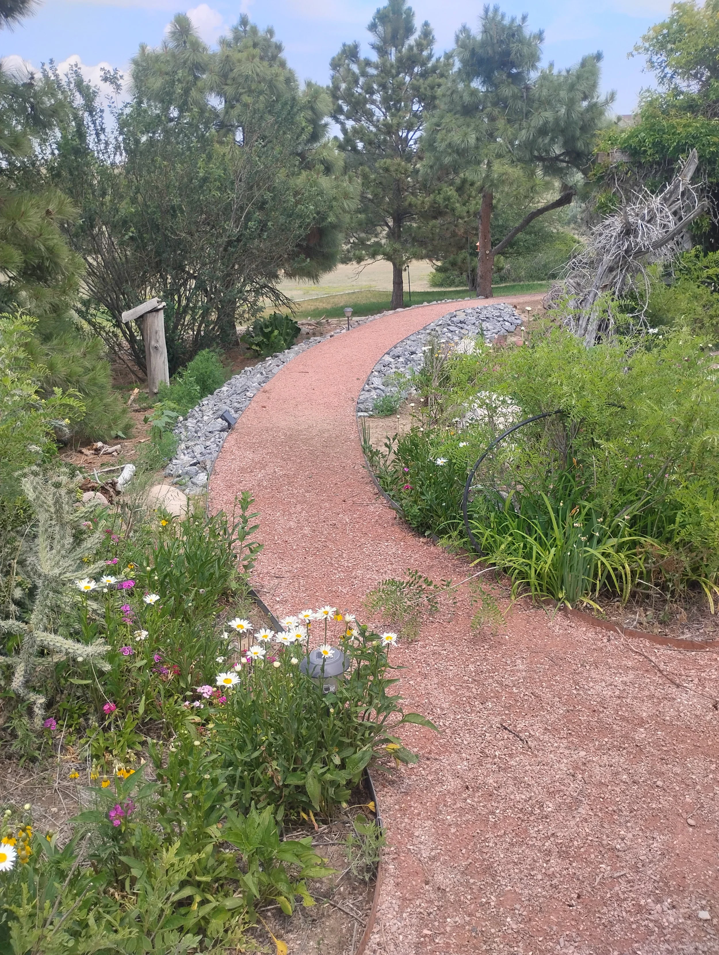 Raised red-breeze pathway through a garden. 