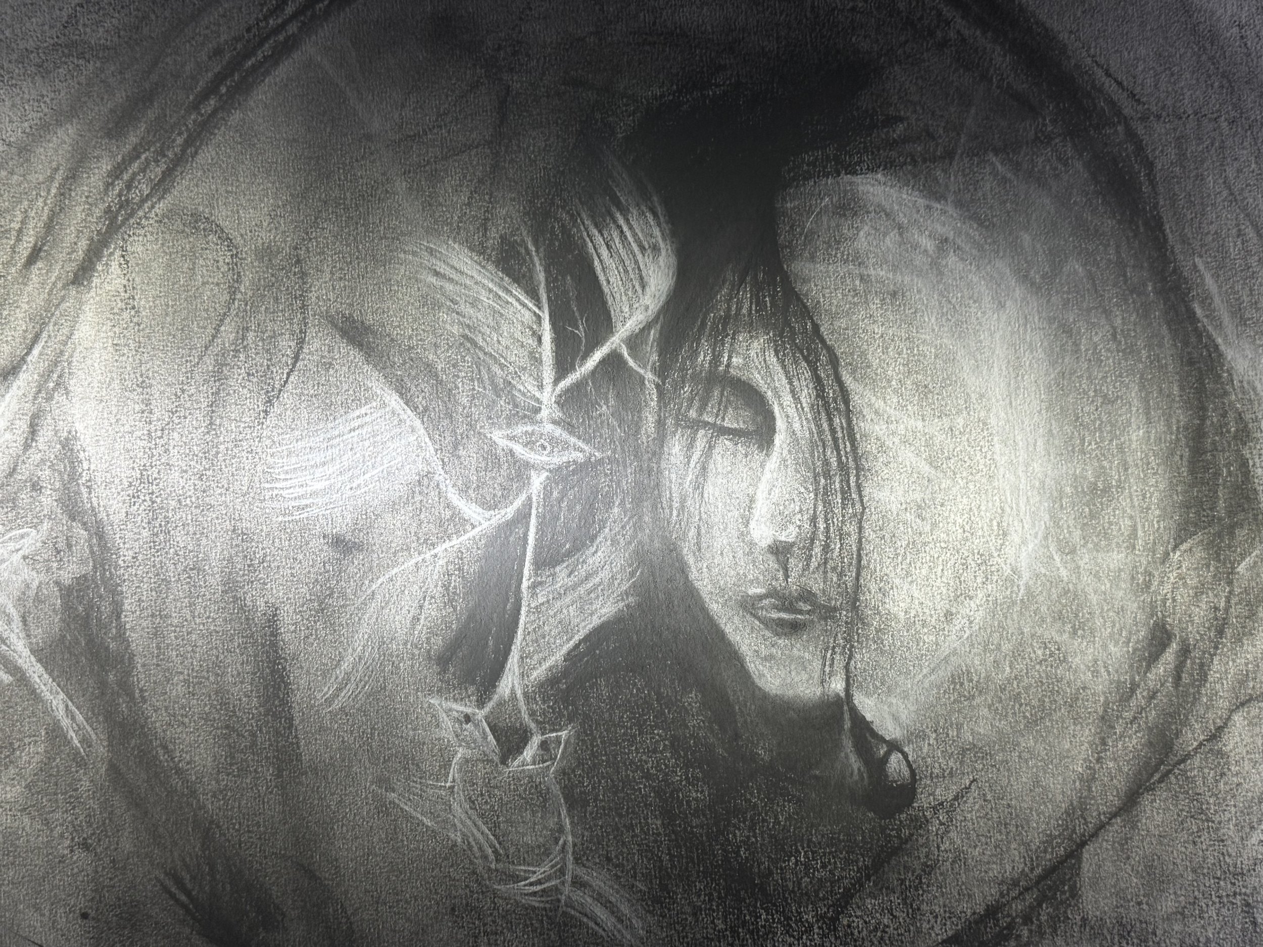 A monochrome charcoal sketch of a woman with closed eyes, delicate features, and long hair, placing her forehead against another person's face, with an angelic figure swaying in front.