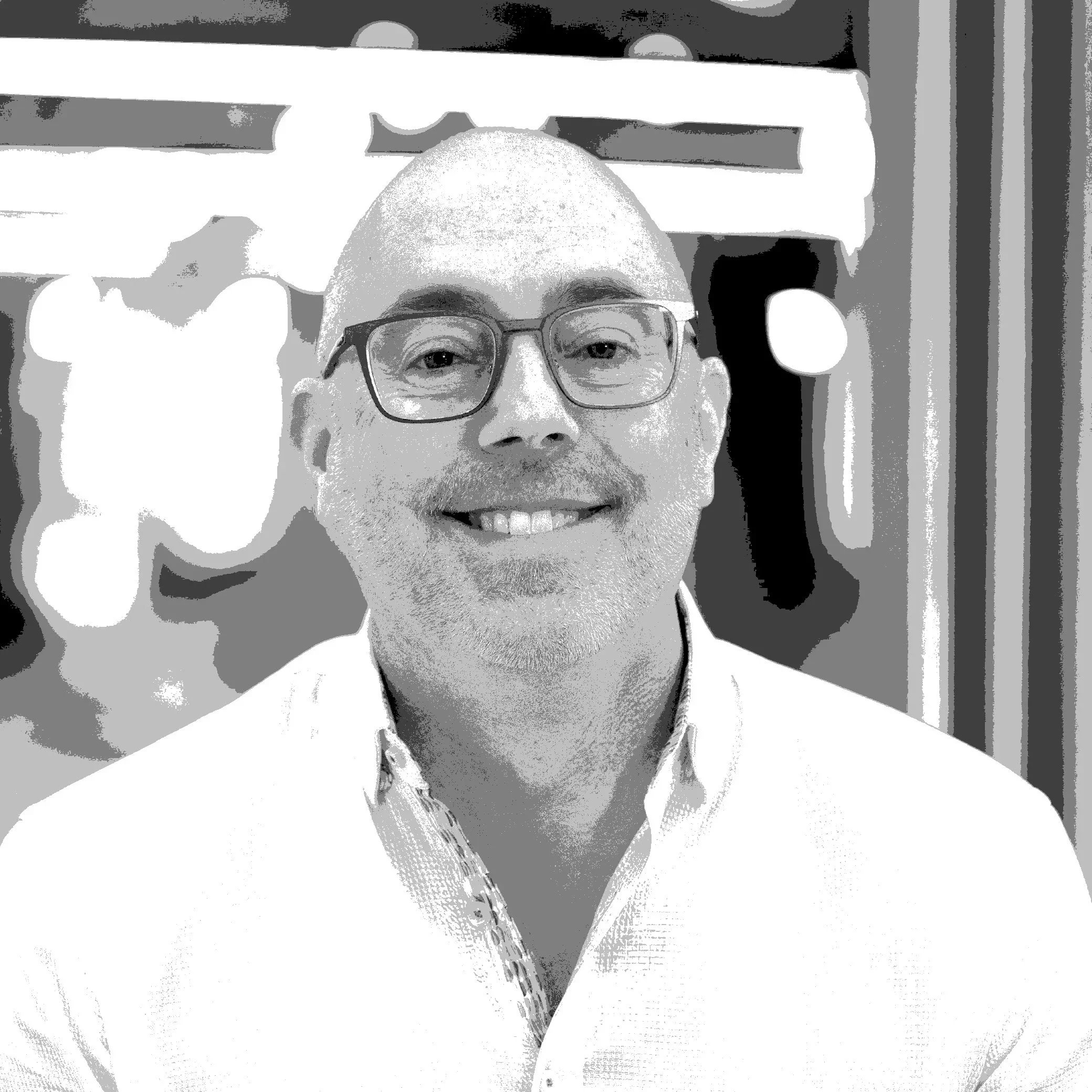 Black and white image of Chris Bevolo smiling at the camera