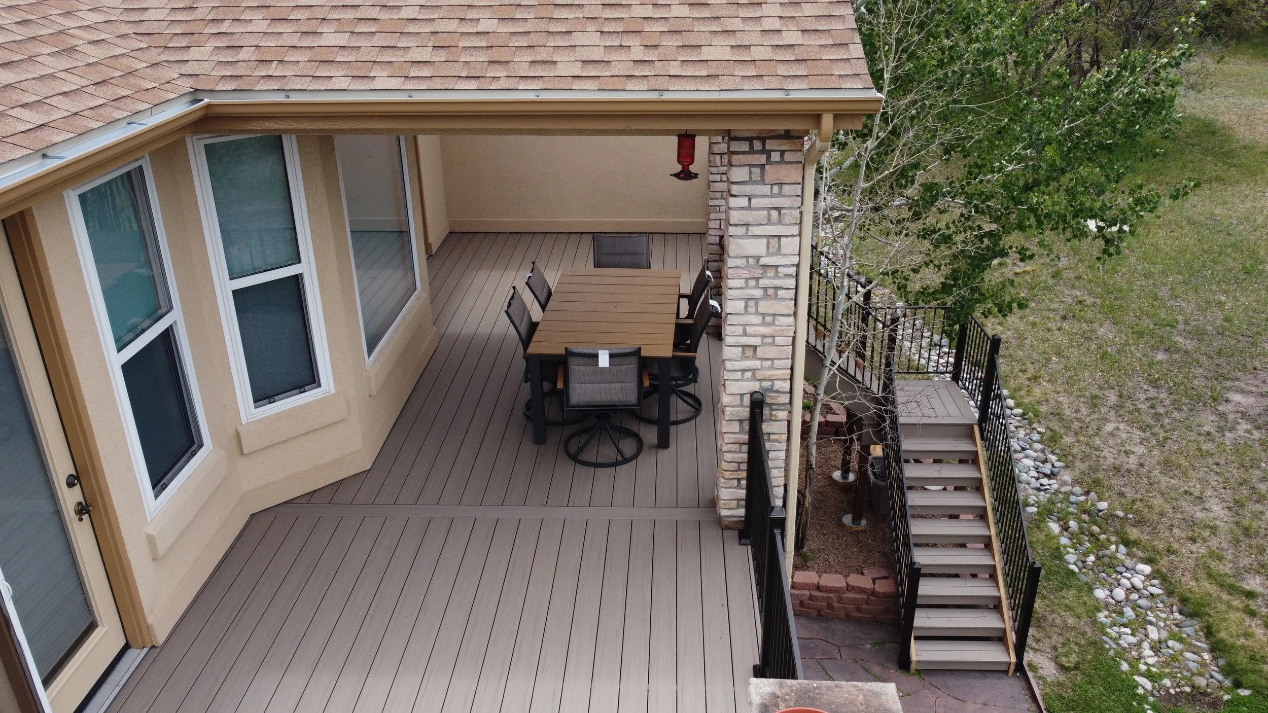 A bird's eye view of a backyard patio deck with Deckorators Decking Installed by Mile High Decks 