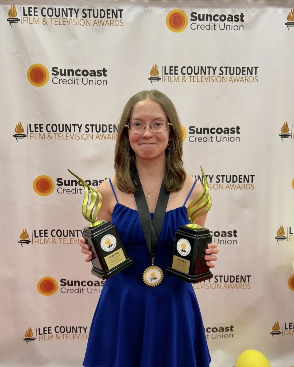 Me standing with my 9-12 Short Film and 9-12 Best in Show awards at the 2024 Lee County Student Film and Television Awards.