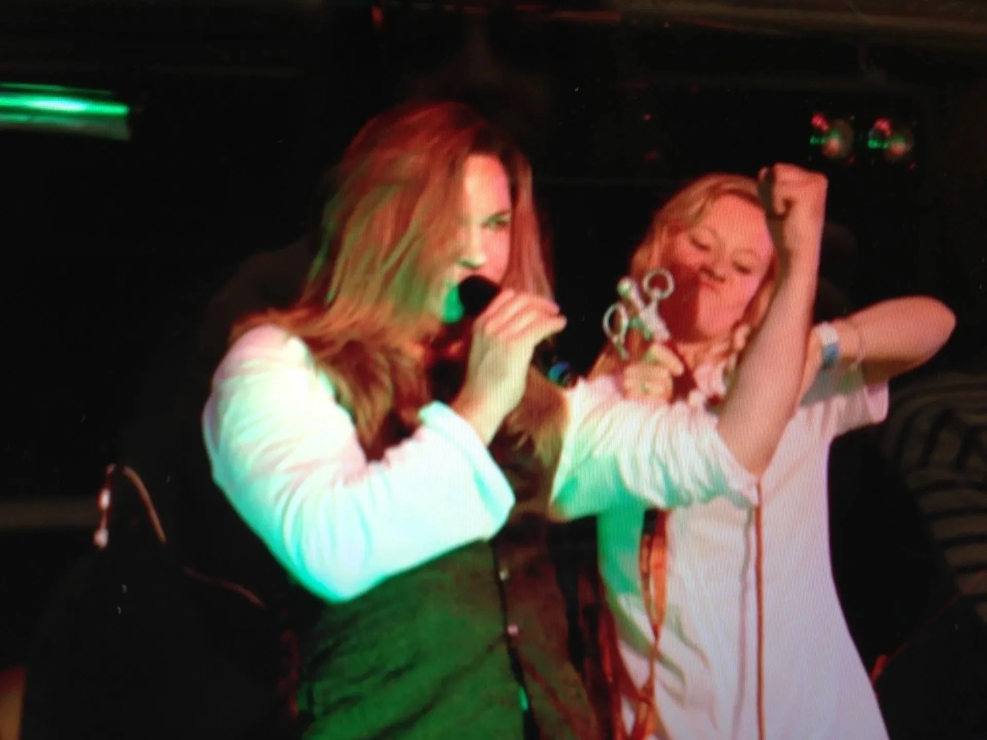 Singer Tracie Law from Symphony of Pain with long blond hair and a women dressed as a nurse acting out one of the songs from the Symphony of Pain album 'Hydeology' in the Cambridge Rock Festival.