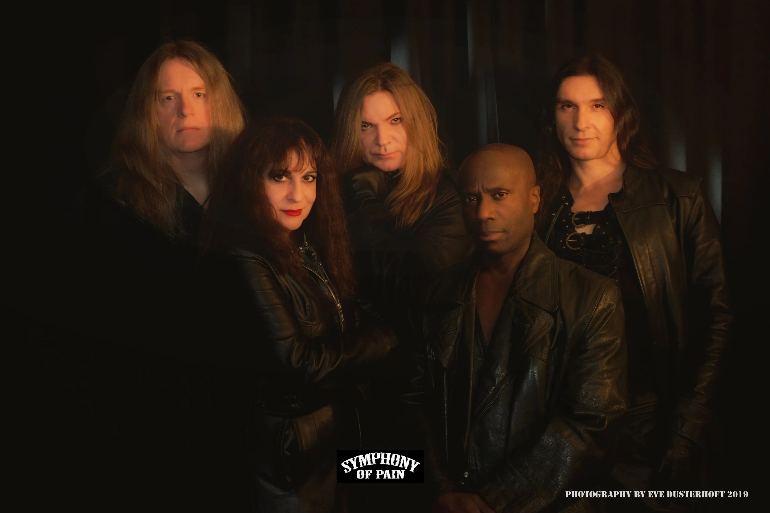 The band Symphony of Pain posing together in a dark setting, all wearing black leather jackets, with a serious demeanor.