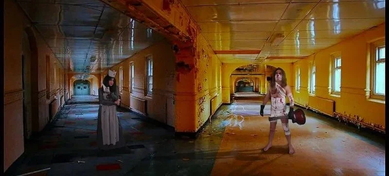 The two songwriters from Symphony of Pain are standing in a long, deserted, and abandoned corridor in High Royds Hospital with yellow-painted walls and windows. One is wearing a black dress, dressed as a nurse and the other is swathed in bandages. 