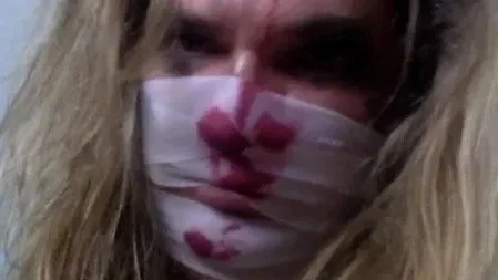 Tracie Law, singer from  band Symphony of Pain with a face wrapped in bandages doing a photoshoot for the inside cover of the album 'Hydeology'.