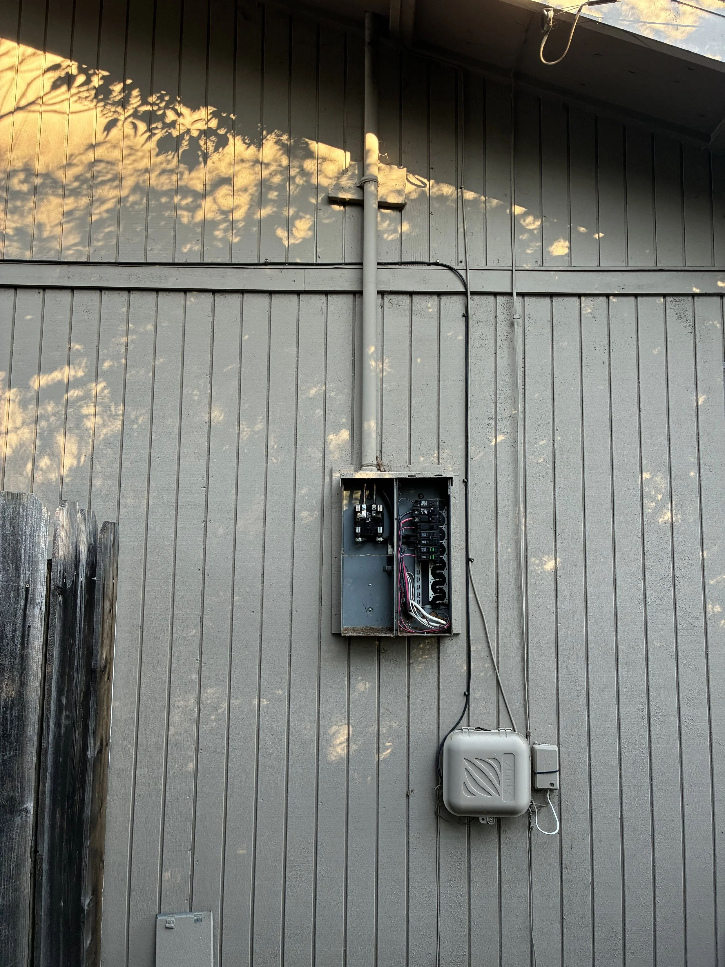 Collins Electric technician installing a higher-capacity electrical panel at a property in Healdsburg, CA.