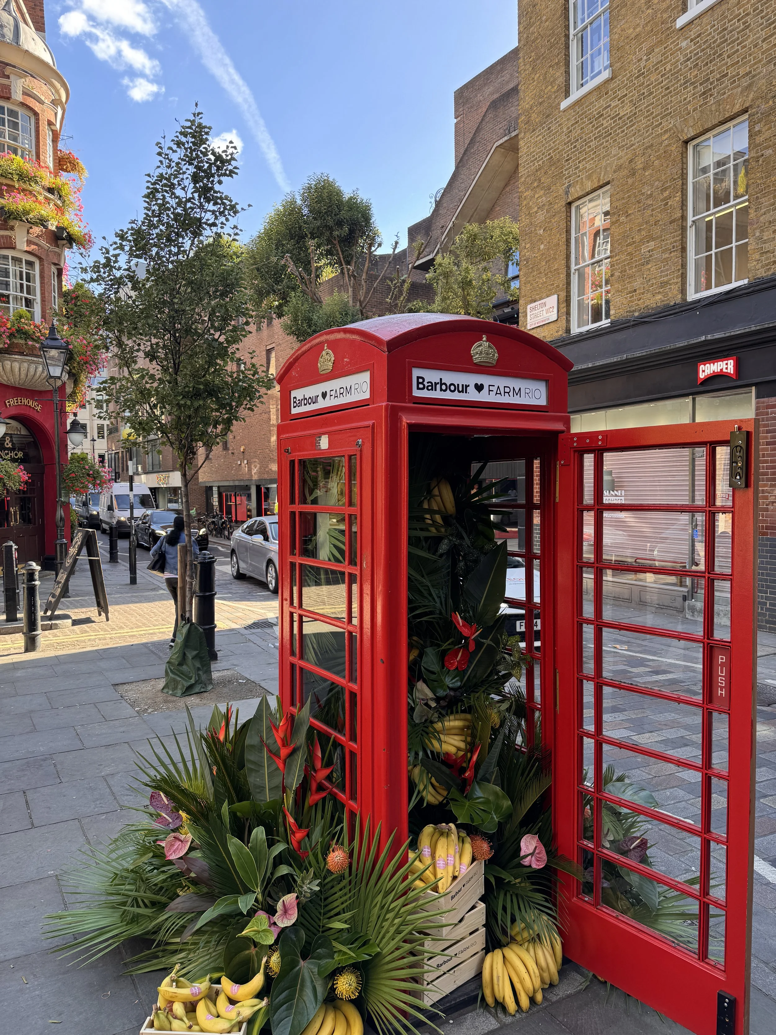 Floral Courier delivered and installed a bespoke tropical floral display for Barbour x Rio, transforming a London red telephone box in Seven Dials with banana plants and lush greenery. A time-critical installation in a high-footfall city location.