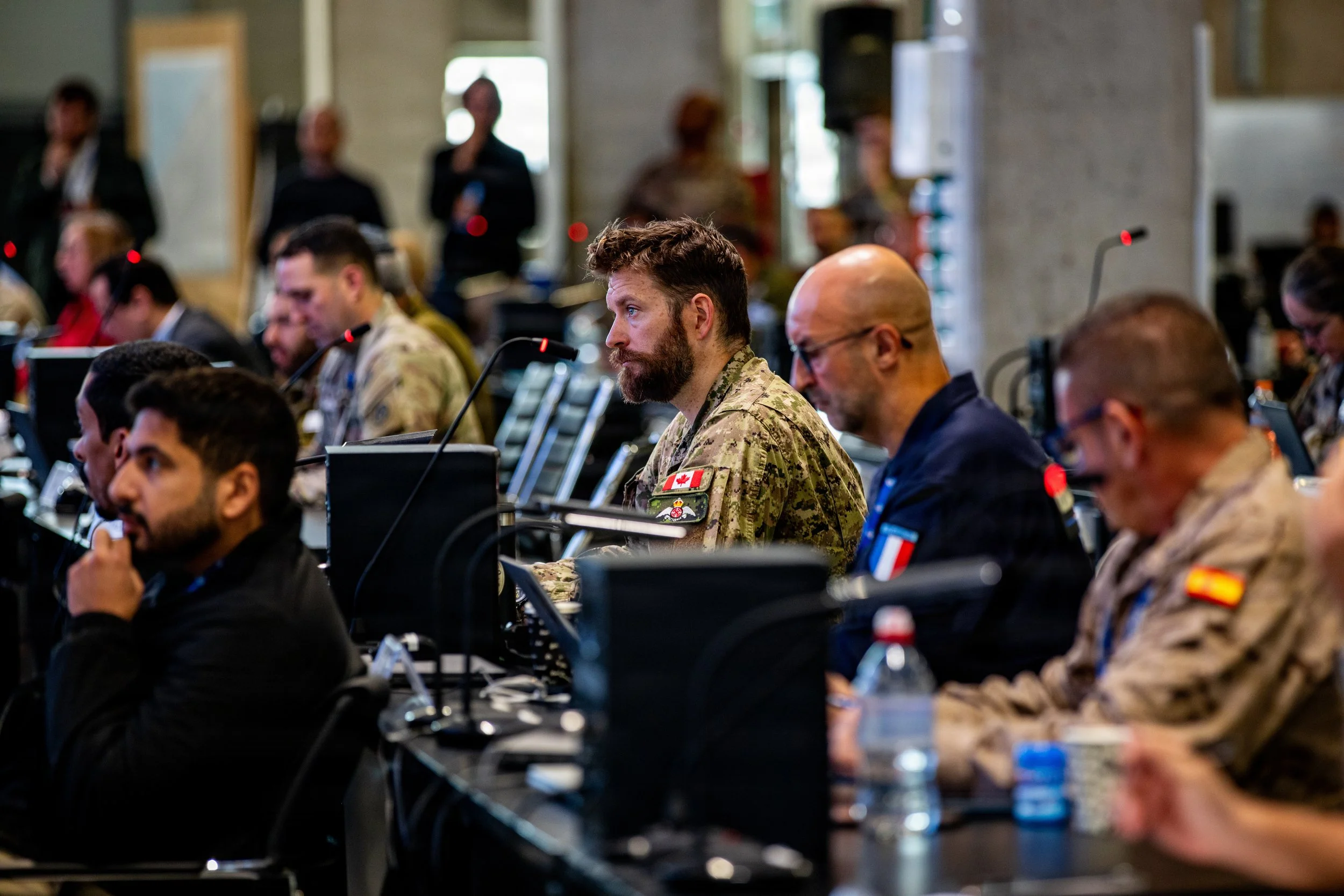 KIRYAT GAT, Israel -- Multinational armed forces and partners from more than 60 nations and non-governmental organizations attend the daily morning update brief inside the Civil-Military Coordination Center (CMCC), Dec. 16, 2025. The CMCC was establi